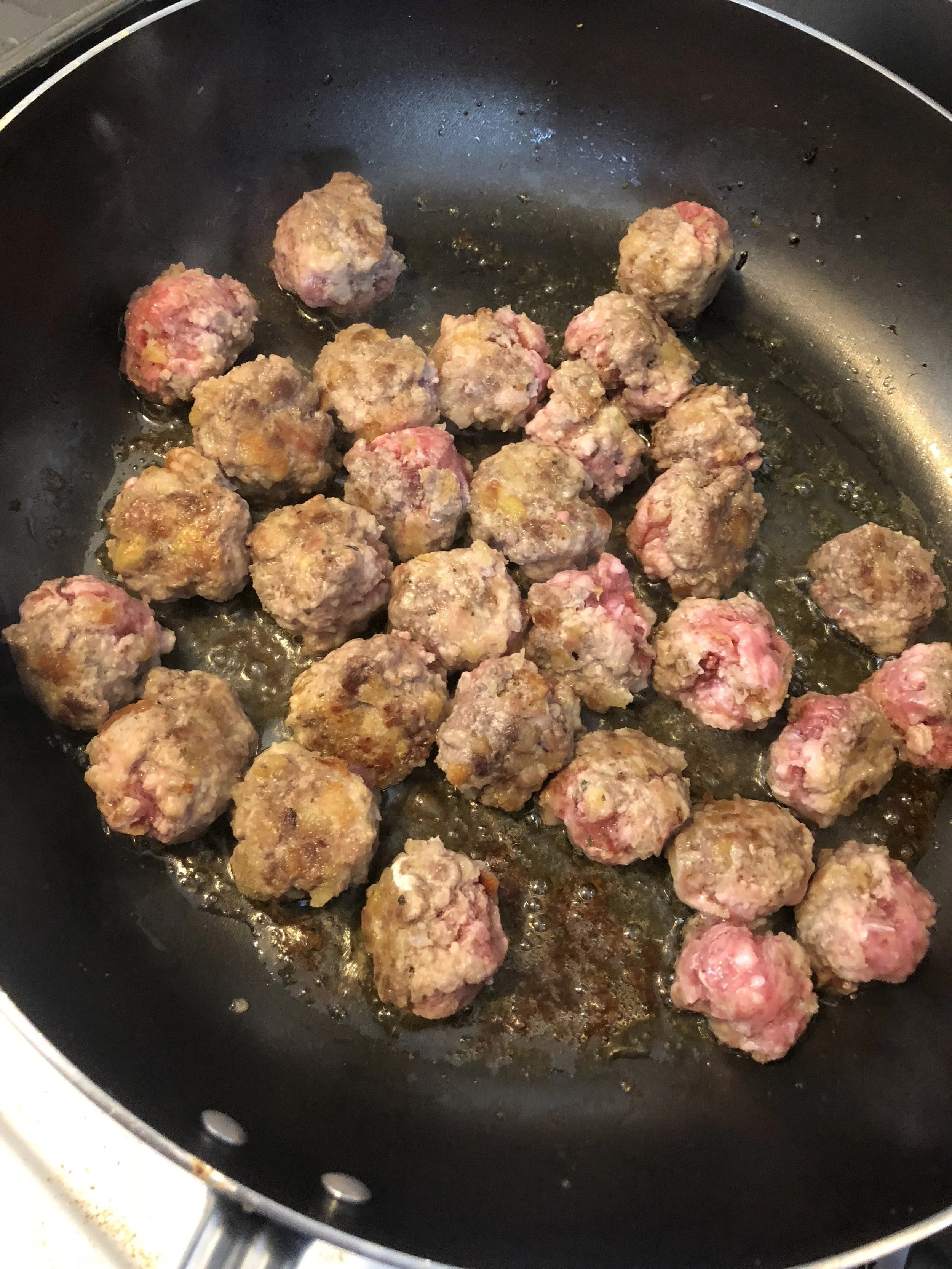 Take your biggest frying pan (yup we’re making meatballs, so it is not a skillet but a legit frying pan today), and pour a tsp of olive oil into the pan, taking care to move it around so the whole bottom is covered.Heat the frying pan until it is ho…