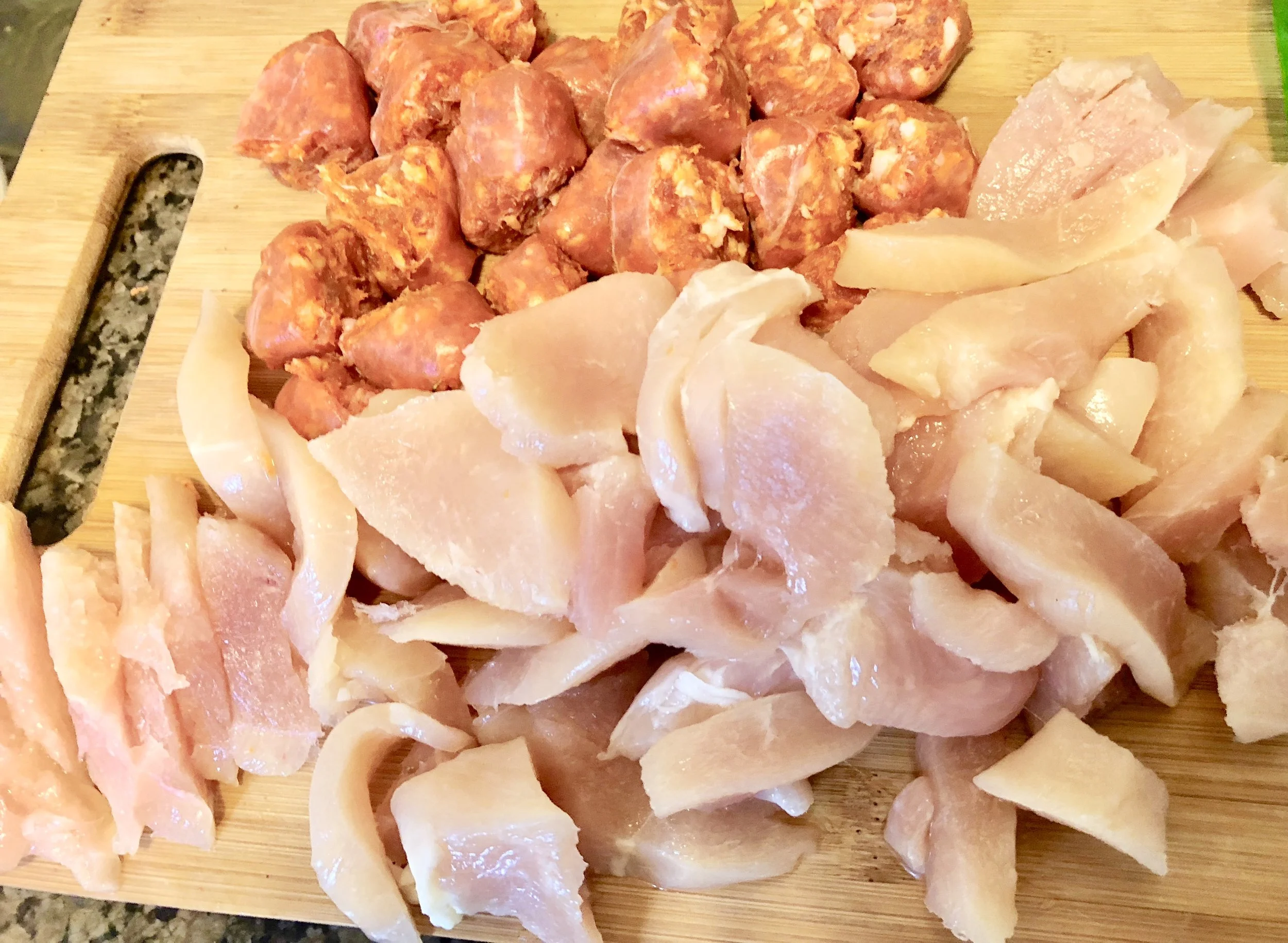 Coin your sausage and clean the chicken breasts of fat and sinew. Slice the chicken into medium same sized pieces. Pour a teaspoon of oil into your medium skillet and when hot, add the sausage and chicken, stirring frequently and cook until both are cooked thoroughly.