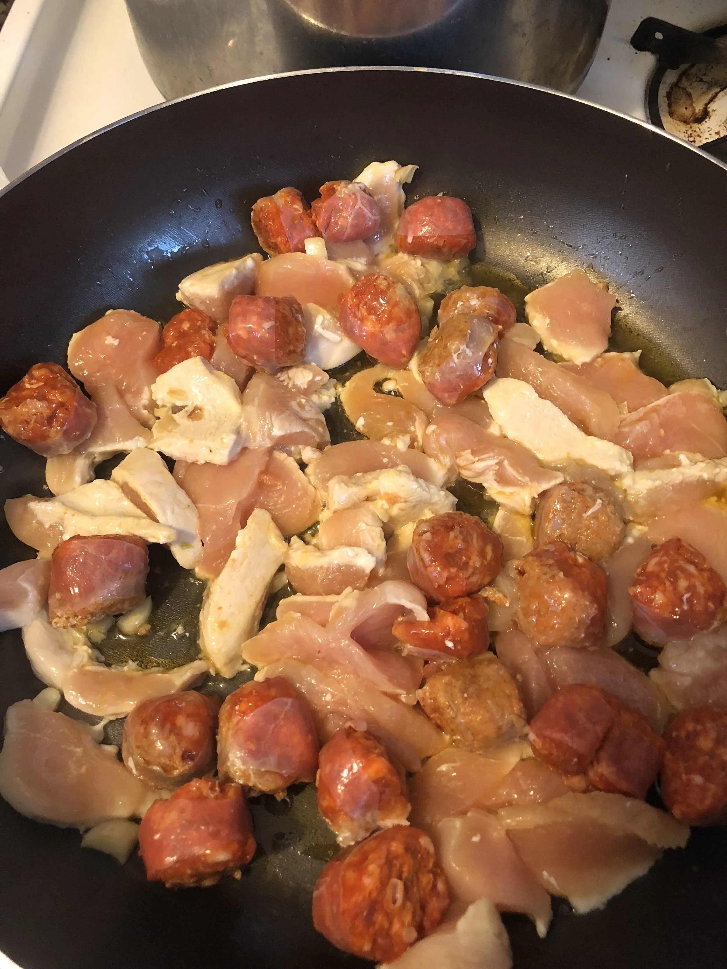 While the chicken and sausage are cooking, dice the onions, garlic, jalapeno, celery and green bell pepper.