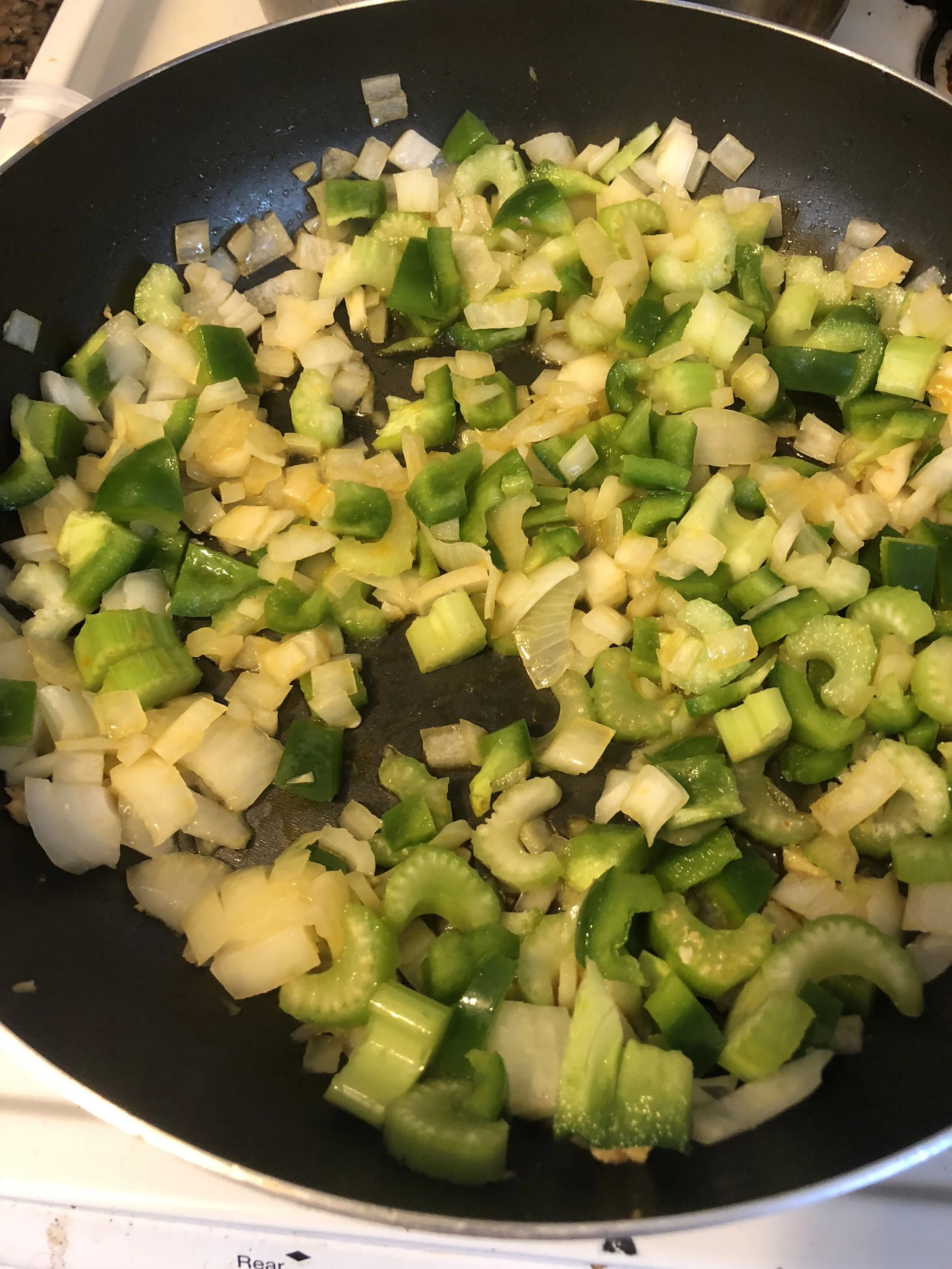 Remove the chicken and sausage (once cooked) from the skillet with your slotted spoon. Put them aside in your mixing bowl. Add the onions, garlic, green bell pepper, jalapeno and celery into the pan with the drippings and cook until aromatic and the…