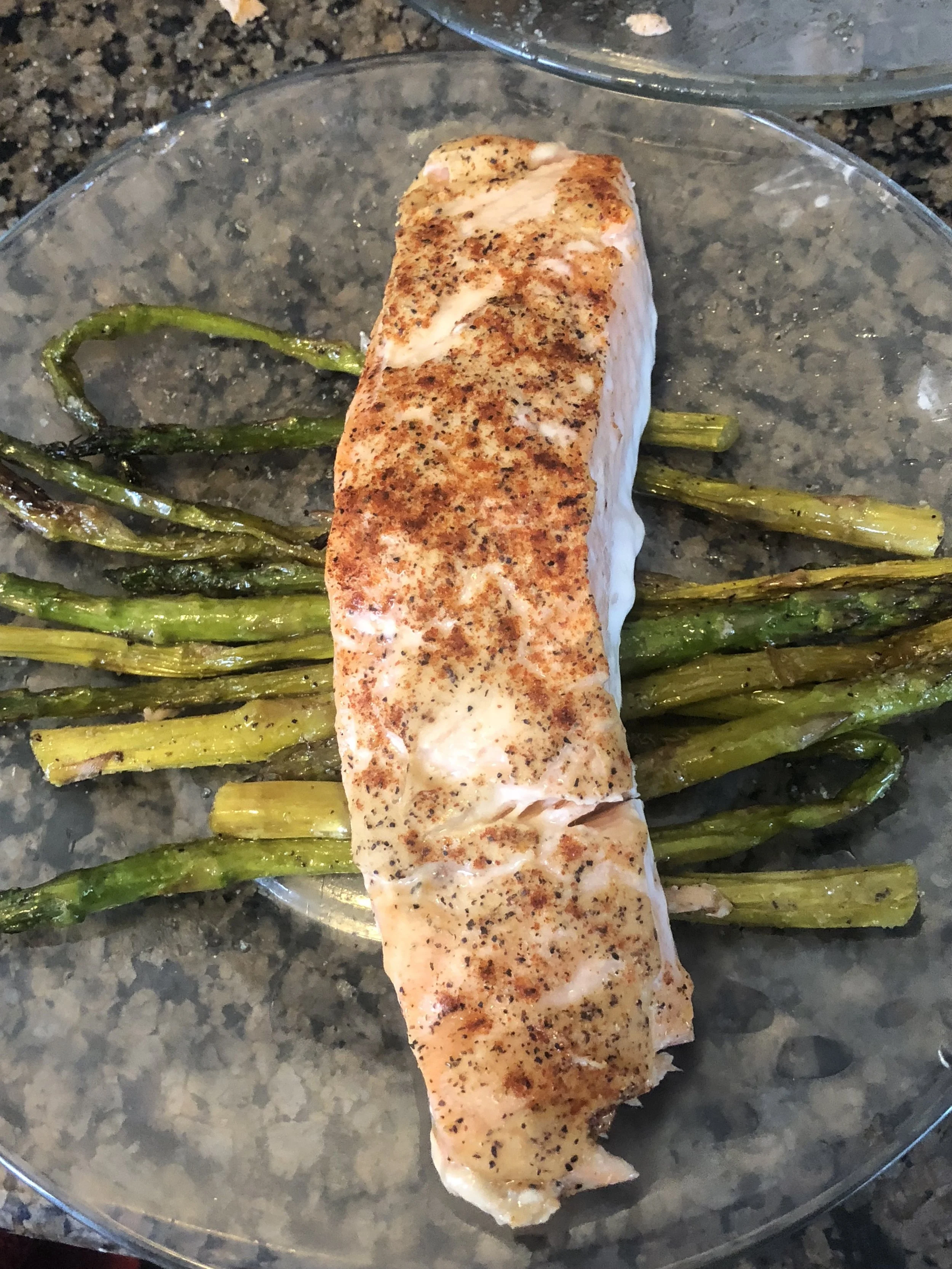 Ingredients medium bunch of asparagus 3 tbls of olive oil salt and pepper powdered garlic 2-3 generous tbls of Dijon mustard paprika optional- herbs of your choosing lb of salmon, defrosted panko ( I made my own mistake accidentally did not use the panko) Plan of attack preheat the oven at 270 degrees trim the asparagus Toss the asparagus with olive oil and season with salt, pepper and garlic place the asparagus on the left side of your sheet pan and set your kitchen timer to 5-6 minutes. put the asparagus in the oven