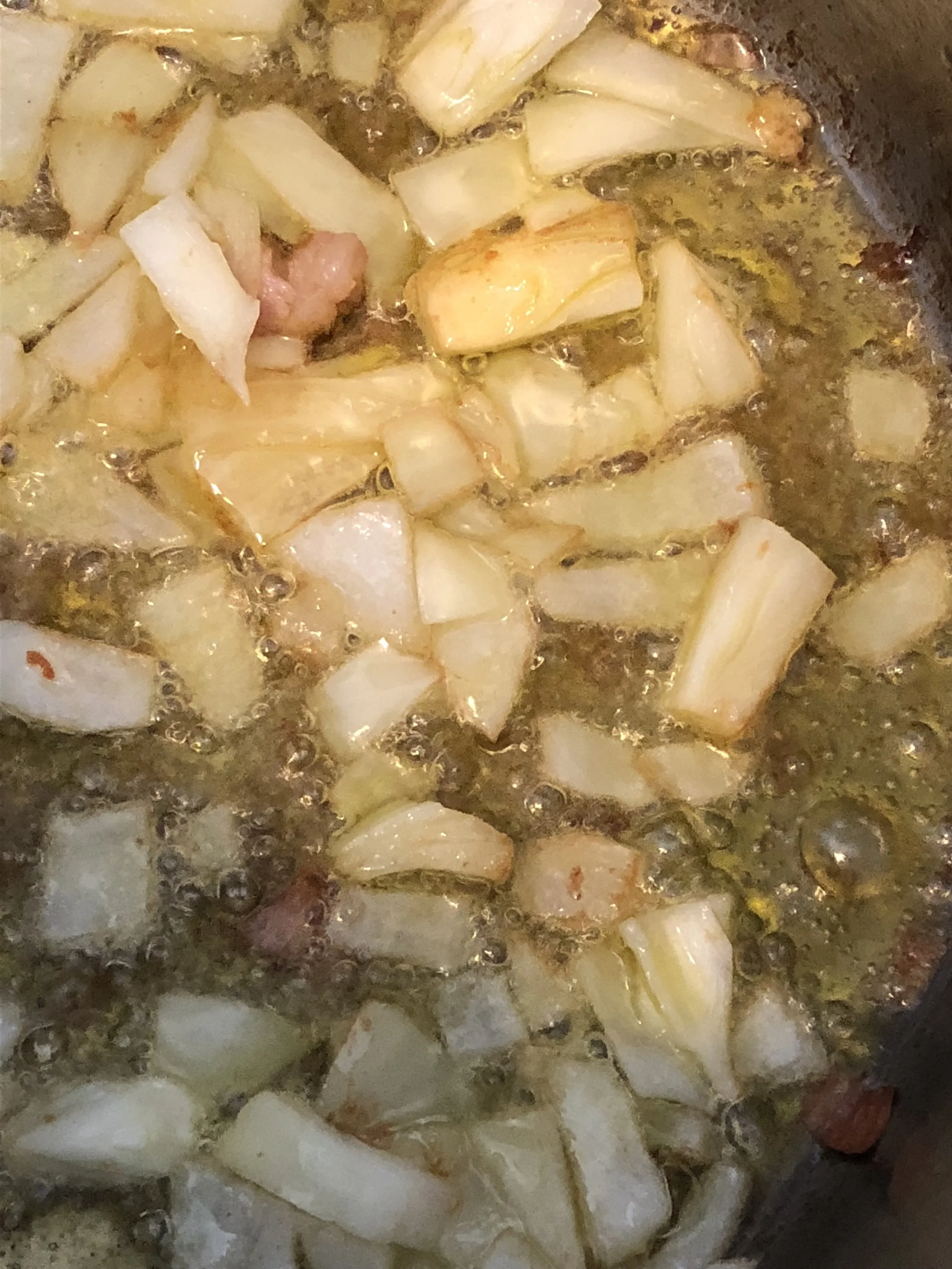 Add the onions and cook until aromatic and clear. Then add the garlic and cook until it is browning but not burnt.