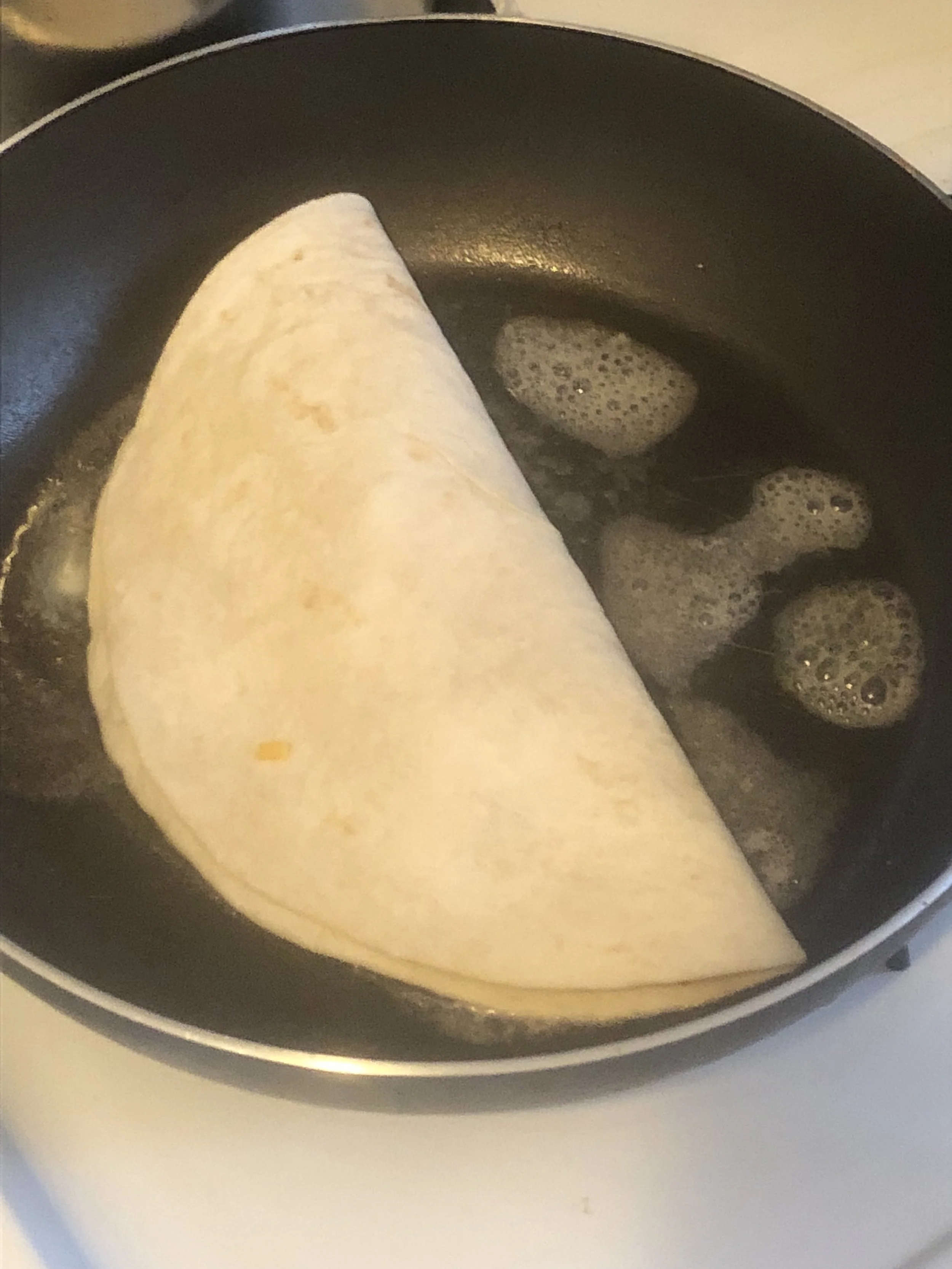 Put your butter in your medium skillet, and cook until the pan is hot. Fold the side of quesadilla over to cover the insides and place in the pan. Allow for the quesadilla to cook and for the cheese to melt, flipping the quesadilla on both side to a…