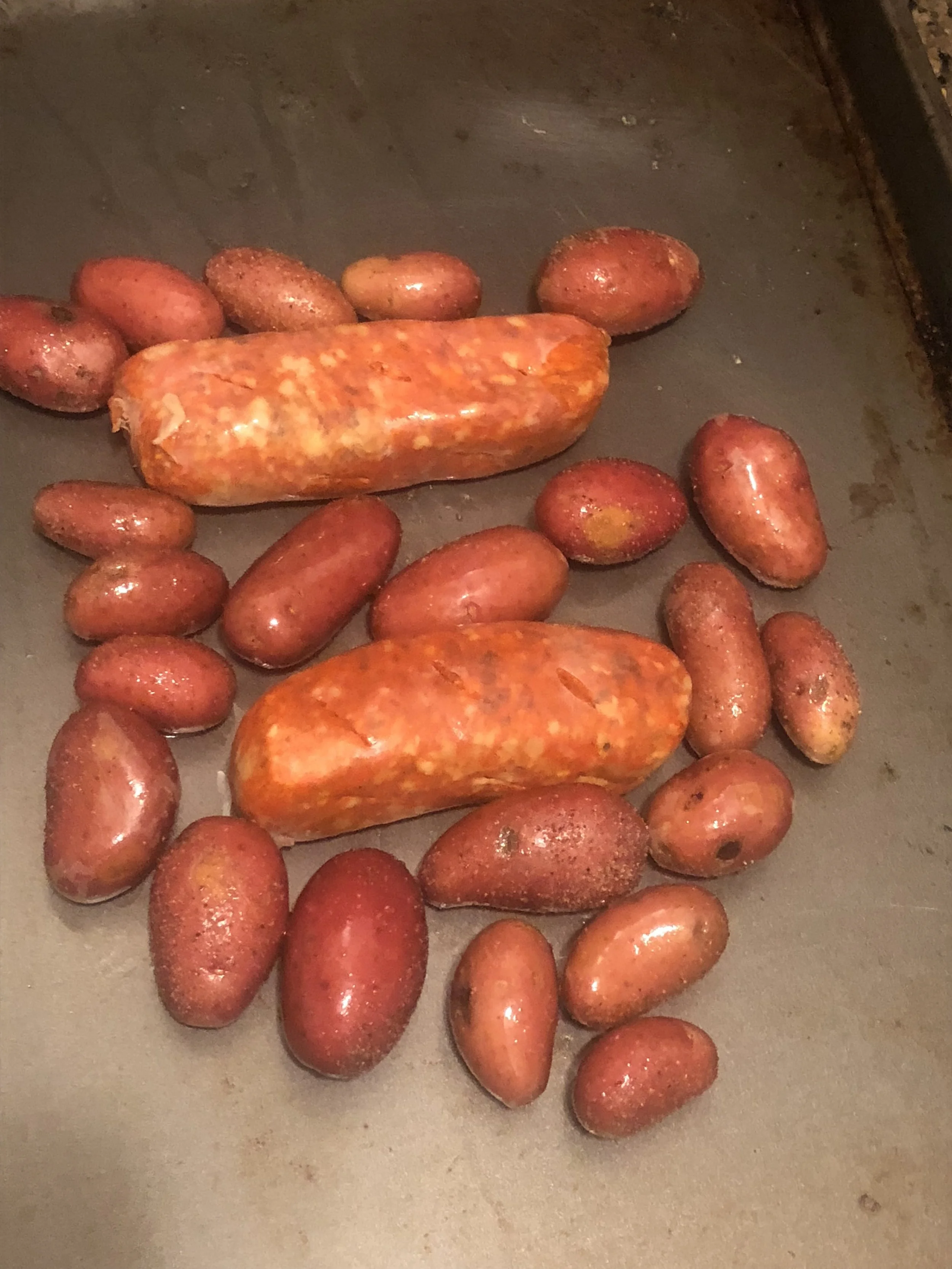 nestle the sausages among the potatoes on your nonstick cooking sheet and put in the oven for 15-20 minutes