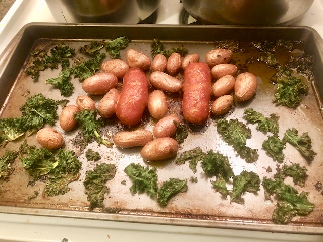 Toss the greens in 3 tbs of the dressing and put on the sheet pan. Return the tray to the oven for 5-6 minutes, or until the kale has charred edges