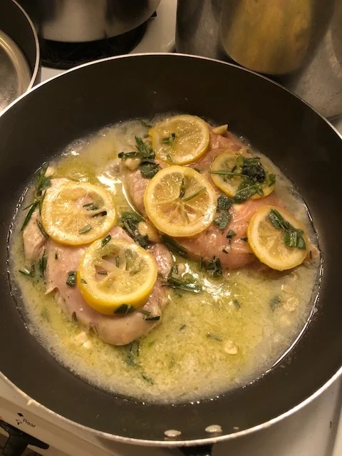 Put 2 tbs of olive in your medium skillet and then cook 3 garlic cloves (diced) until aromatic. then, empty the contents of the gallon bag into the skillet, being careful to put the lemon slices on top of the chicken breasts