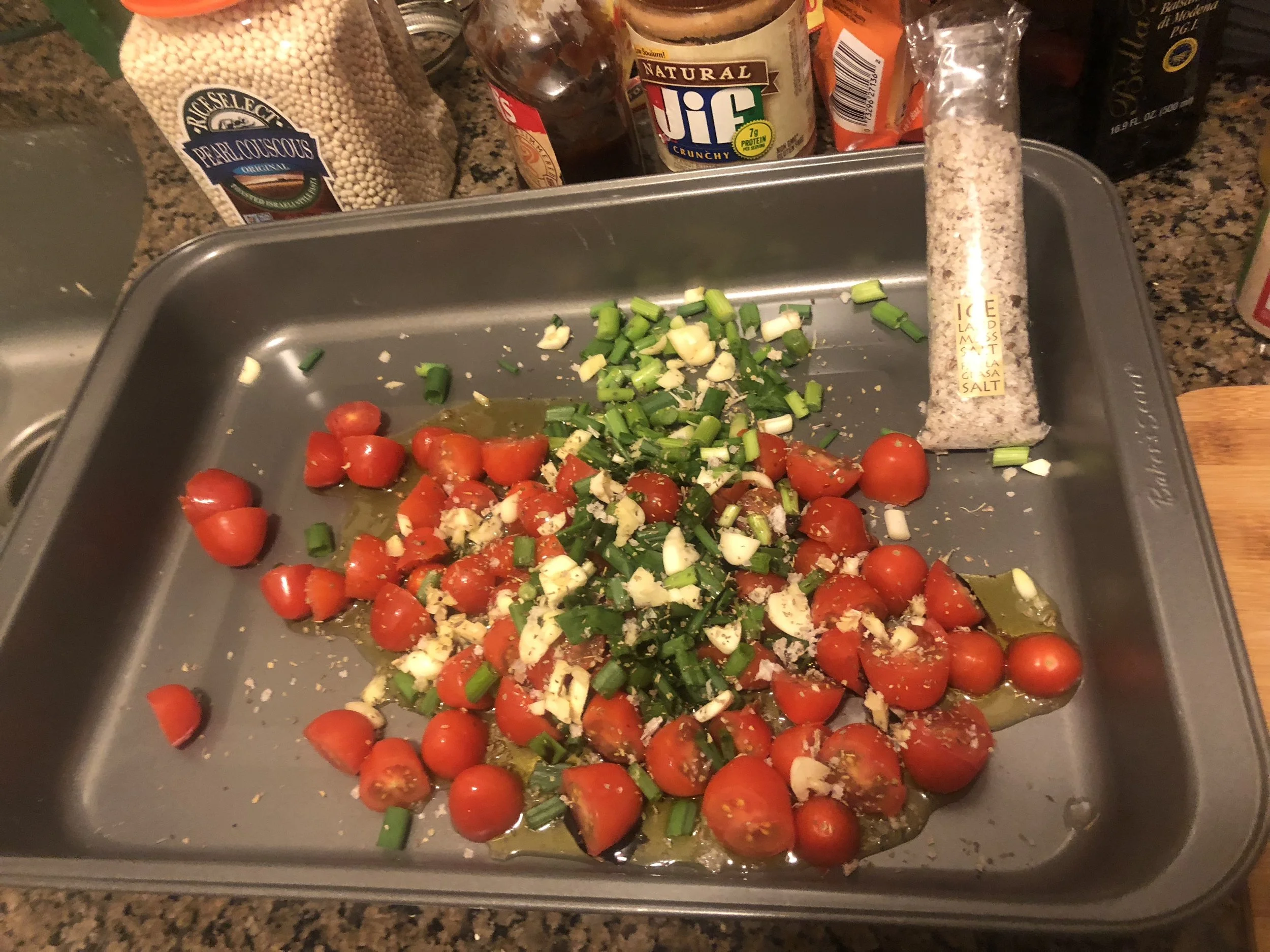 Cut the tomatoes down the middle, dice the garlic Cloves and finely dice the scallions, Toss with olive oil, balsamic, powdered garlic, salt and pepper.