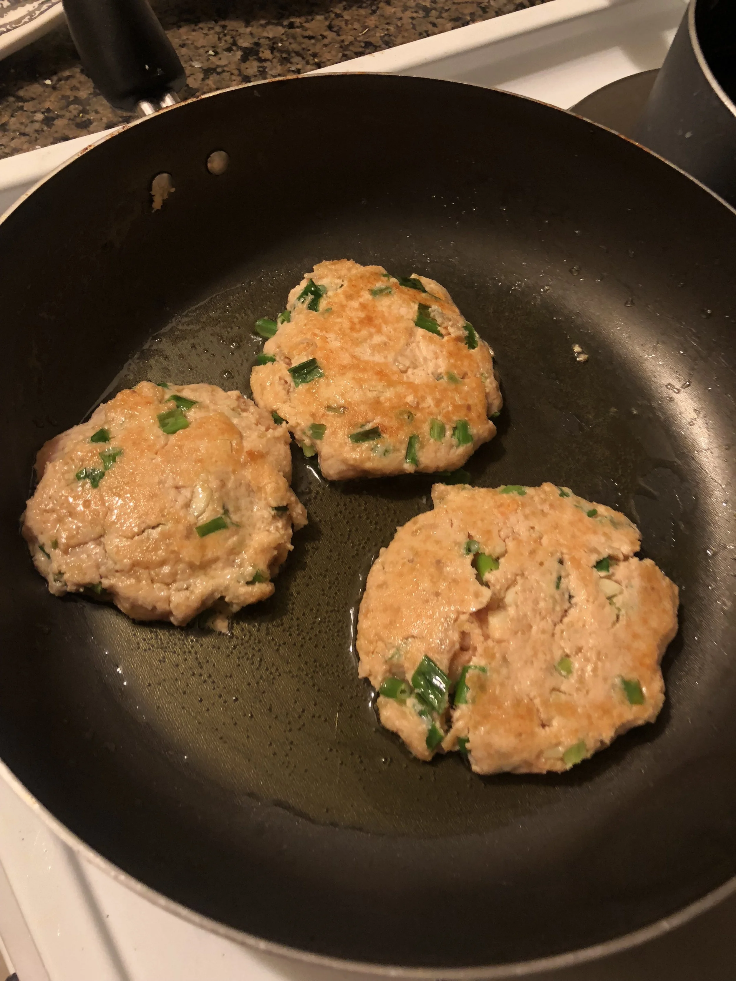 Pour olive oil into your medium skillet and place the cakes on medium high heat into the skillet. Unlike Salmon steaks, which you are supposed to turn once (twice is burgeoning on an insult to the salmon), your can frequently turn these burgers to e…