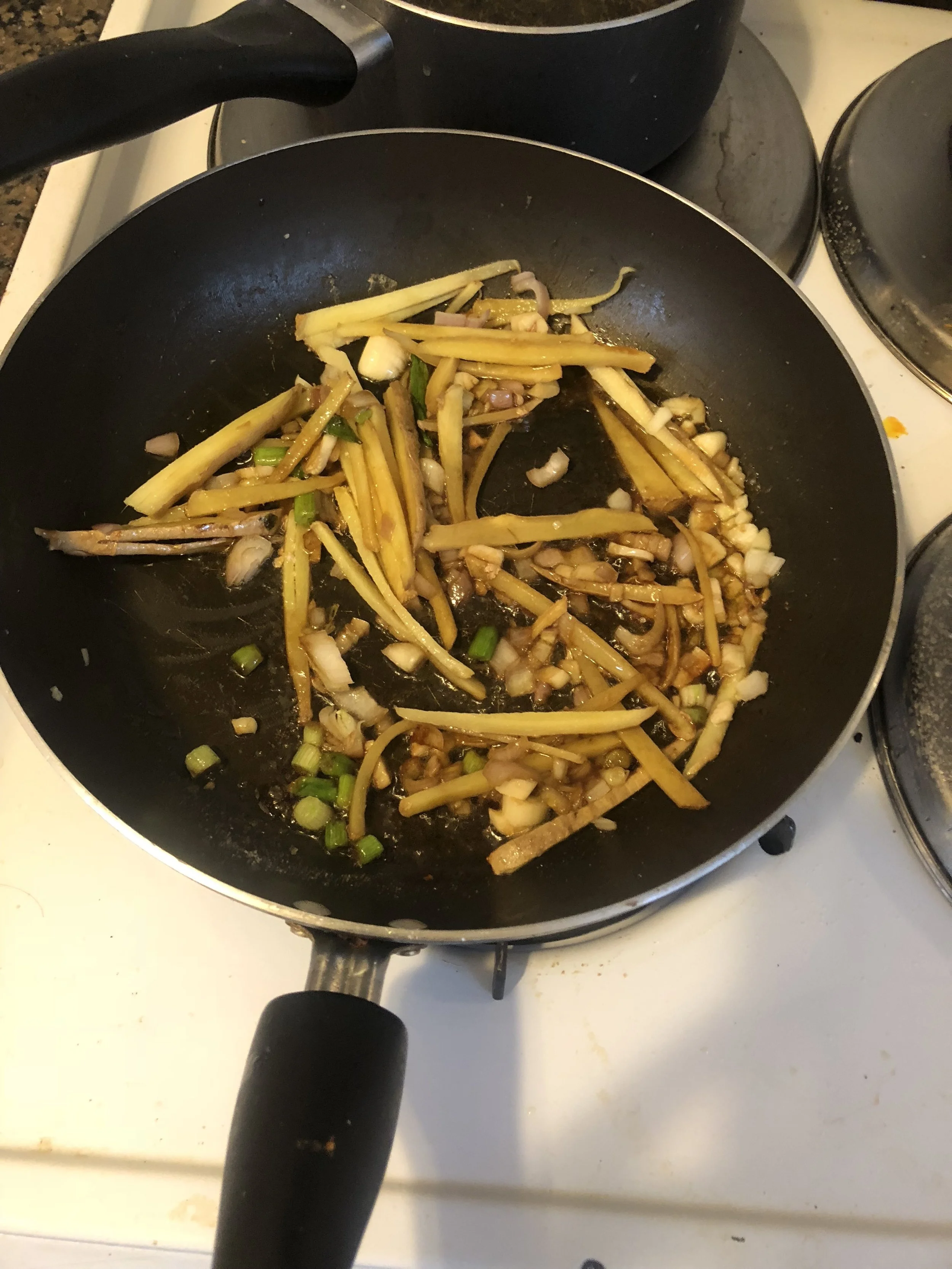 Cut the ginger into straws, dice the garlic and make the scallions into coins.Add 3 tbls of olive oil to the pan and when hot, add the ginger, scallions, and garlic. Sauce the savory ingredients until the ginger is cooked subtle.Cut the chicken brea…