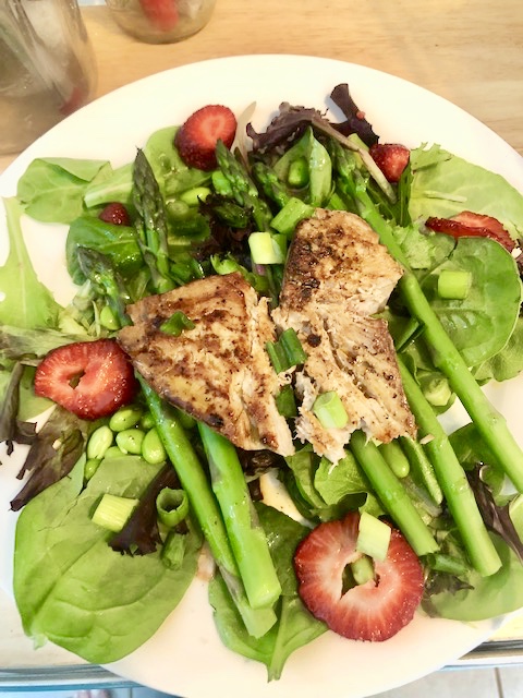 Ingredients 2 cups of mixed greens 5-6 stalks of celery 2 strawberries medium diced scallion an abundance of edamame Tuna steak portioned salt and pepper lemon 2 tbs of soy sauce tsp of honey tsp of Wasabi 3 tbs of rice wine vinegar 2 tbs of olive oil (or so) Plan of Attack Put on a pot of salted water to boil When boiling, add trimmed asparagus and cook for 2-3 minutes. Drain immediately and run cold water over the asparagus until cool. Set aside. Season the tuna steak on both sides with salt and pepper and put a tbs of olive oil into your medium skillet. When hot add the tuna and slice lemon wheels onto the top, turning frequently. Whenever you turn, try and keep lemon underneath nd lemon on top to retain moisture. While the tun cooks assemble the dressing. Whisk the soy sauce, honey, rice wine vinegar, wasabi, and olive oil. Prepare the vegetables and then place the cooked tuna on top. and drizzle with the prepared dressing. Enjoy!