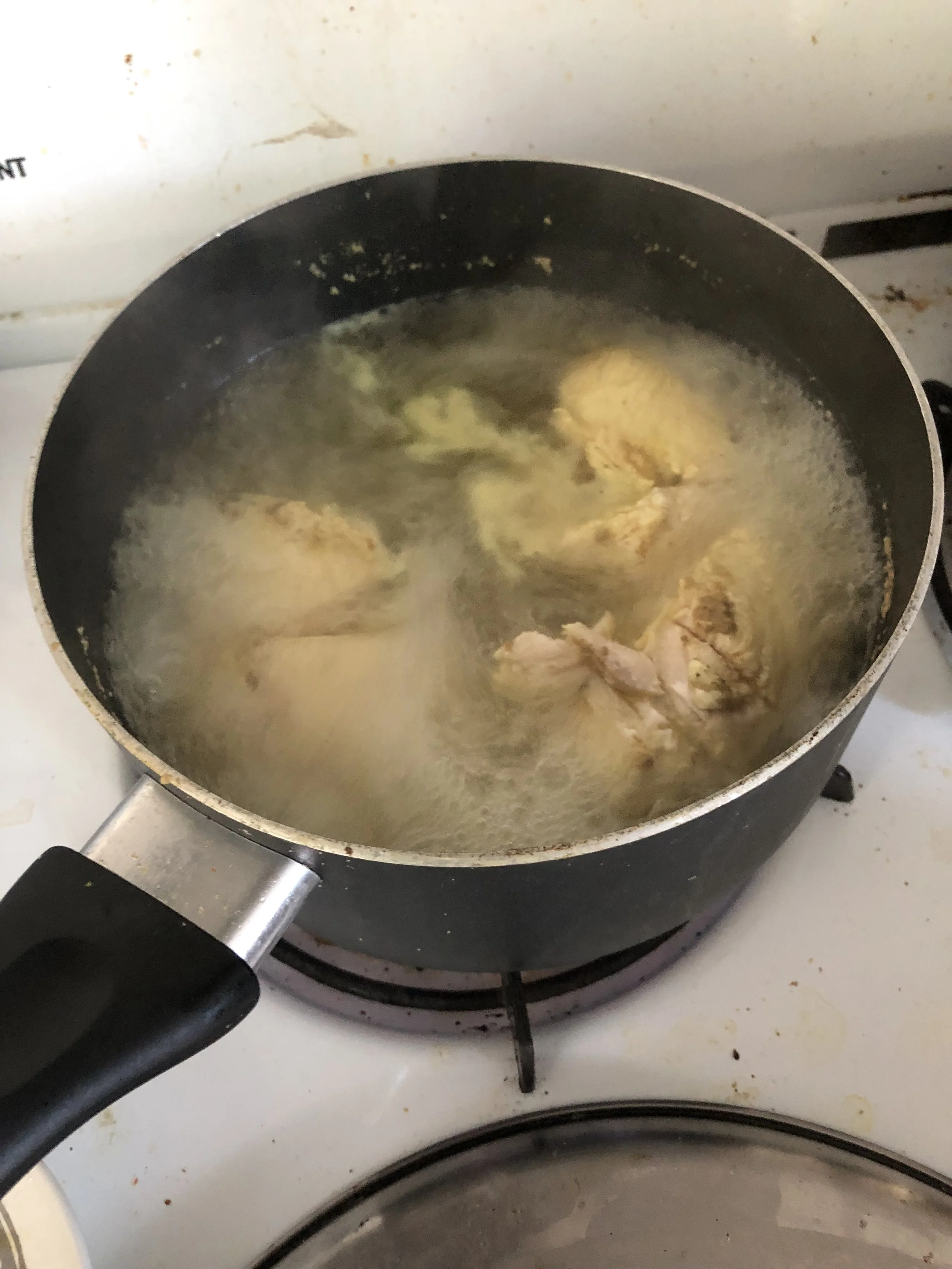 Poach your chicken pieces by adding a packet of Goya chicken seasoning to a medium saucepan of boiling water and cooking in the hot water until cooked through. Remove the chicken and when cooled, shred with your fingers..While the chicken cooks, whi…