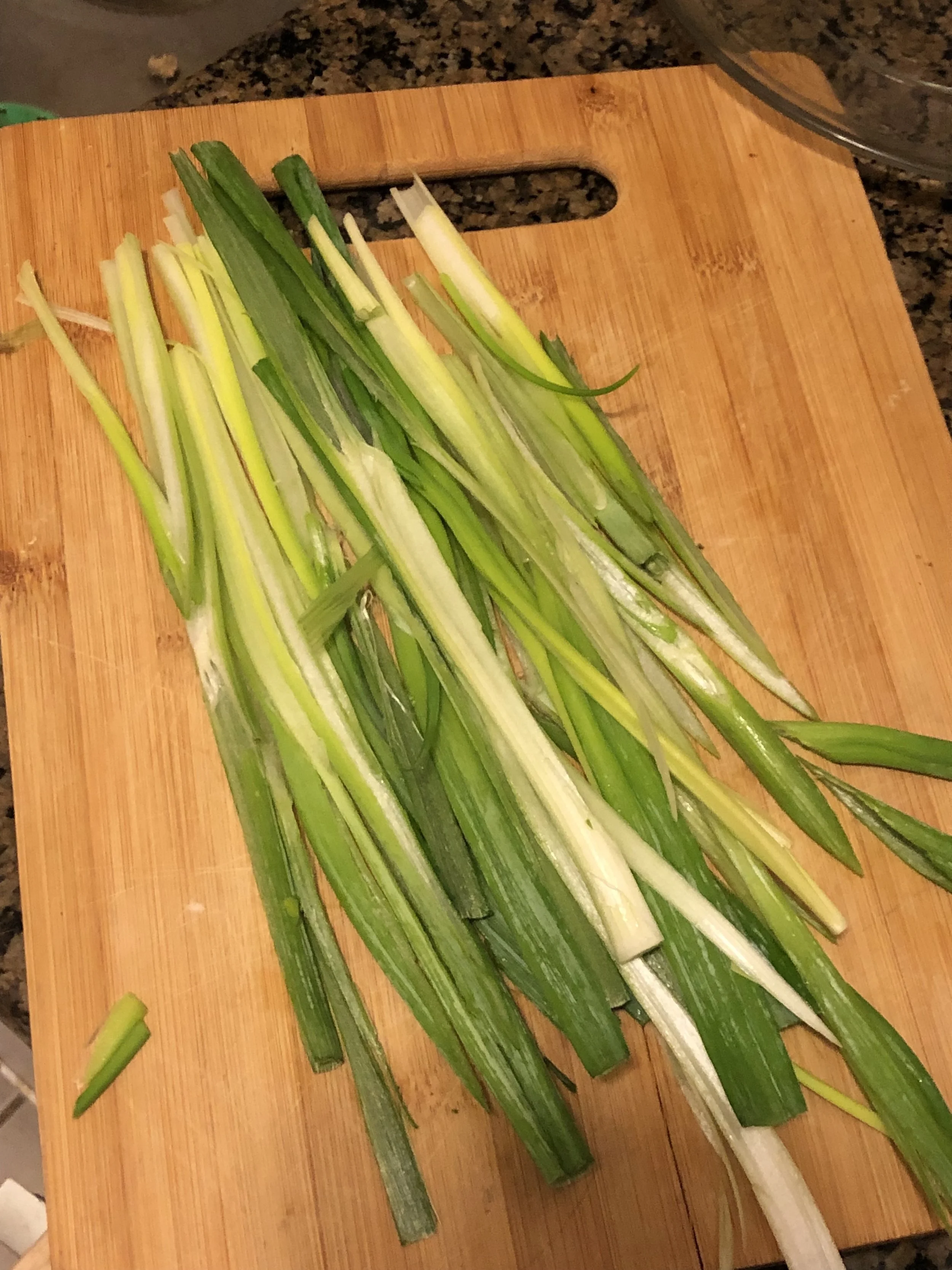 Preheat the oven to 450 degreesCut your scallions into ribbons after trimming the tough ends. Toss with olive oil, salt, pepper and powdered garlic.