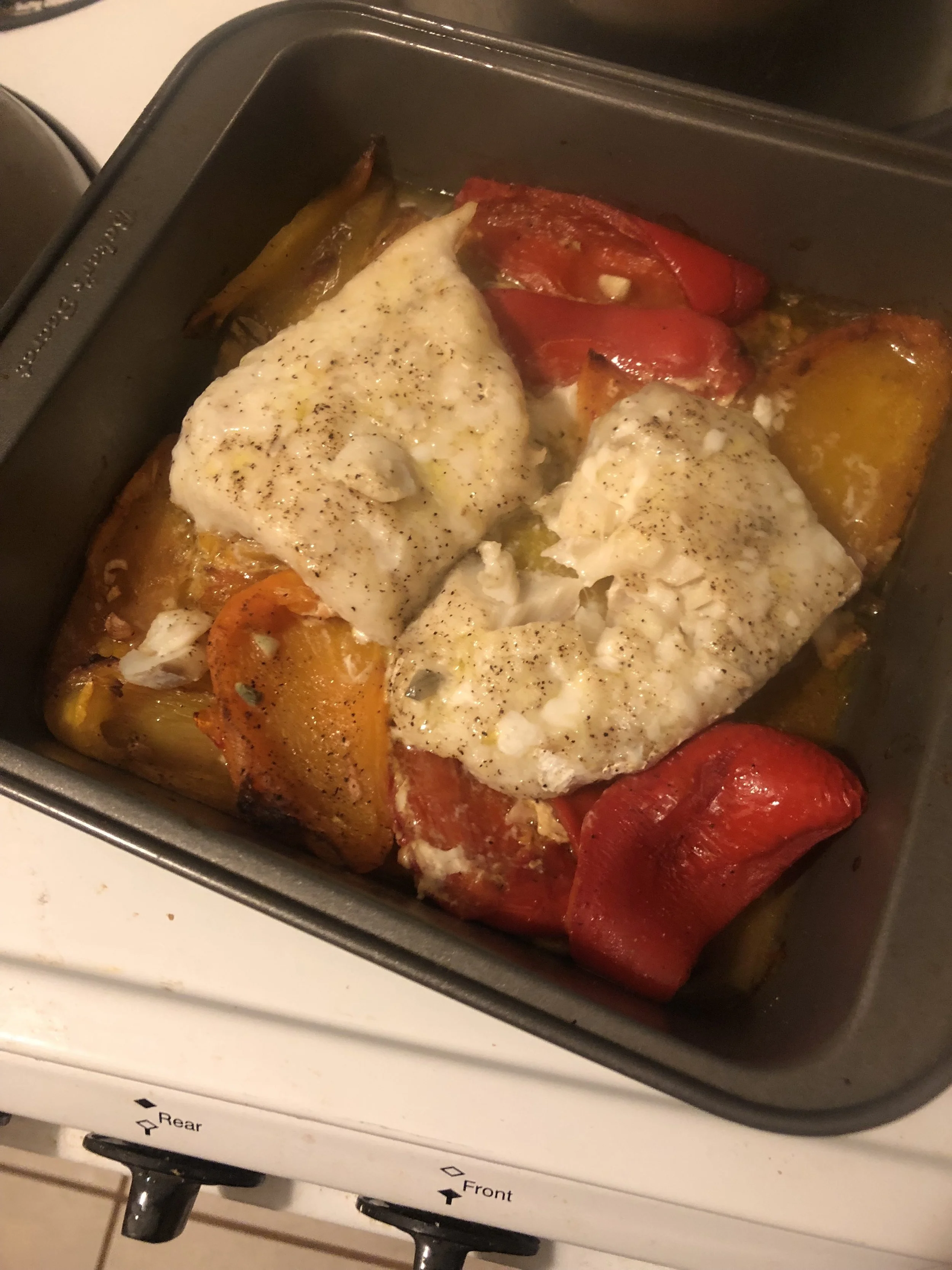 Nestle cod into bell pepper mixture, drizzle with 2 Tbsp. oil, and season with salt and black pepper. Roast on center rack until flesh is opaque throughout and flakes easily when pressed, 25–30 minutes. Let rest 10 minutes.