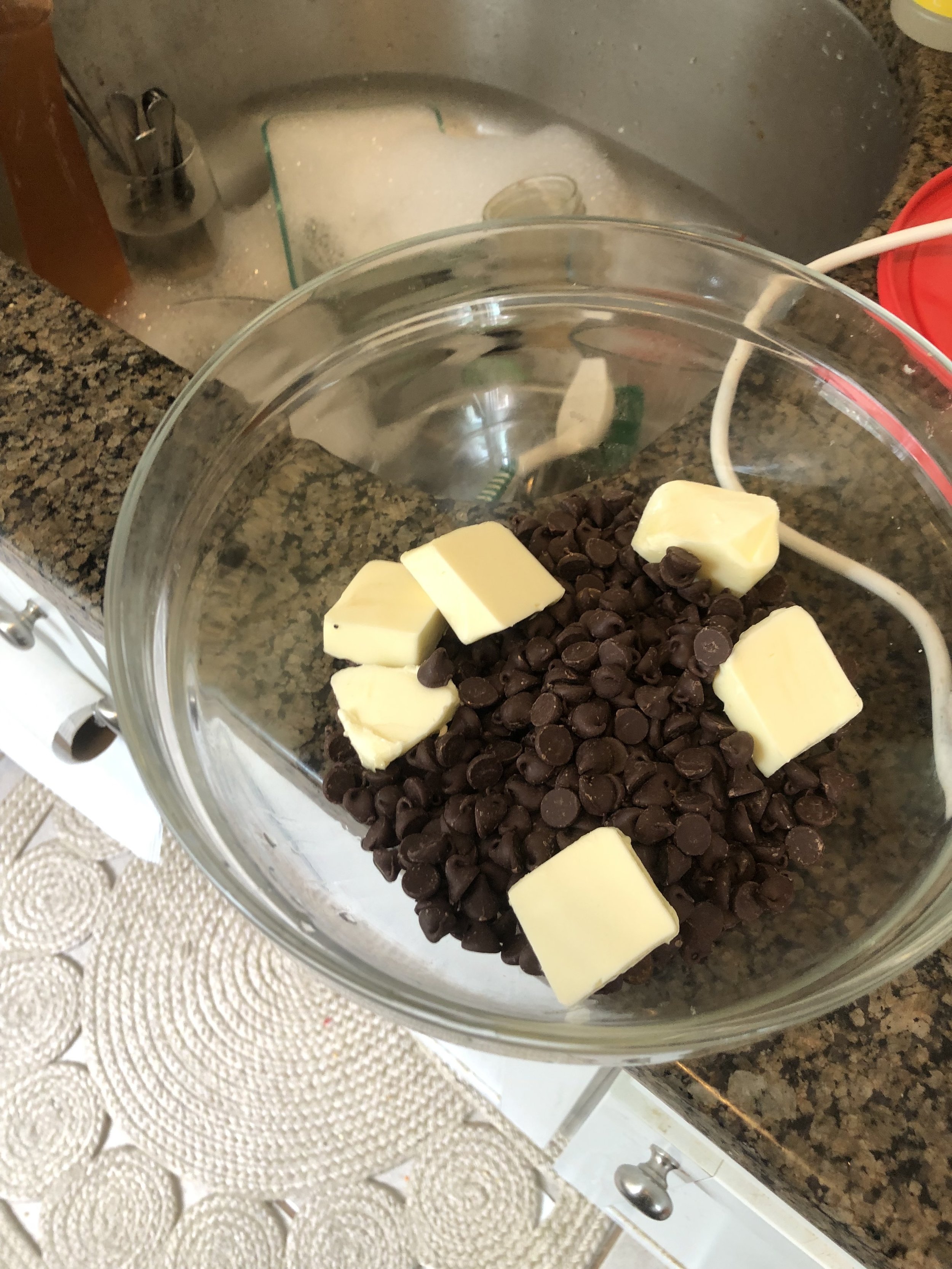 Preheat the oven to 300-325 degrees depending on how hot your oven runs, Cut the butter into pats for easier melting and put in a microwave safe bowl with the chocolate chips. Melt the the ingredients in the microwave in 30 second intervals, taking …