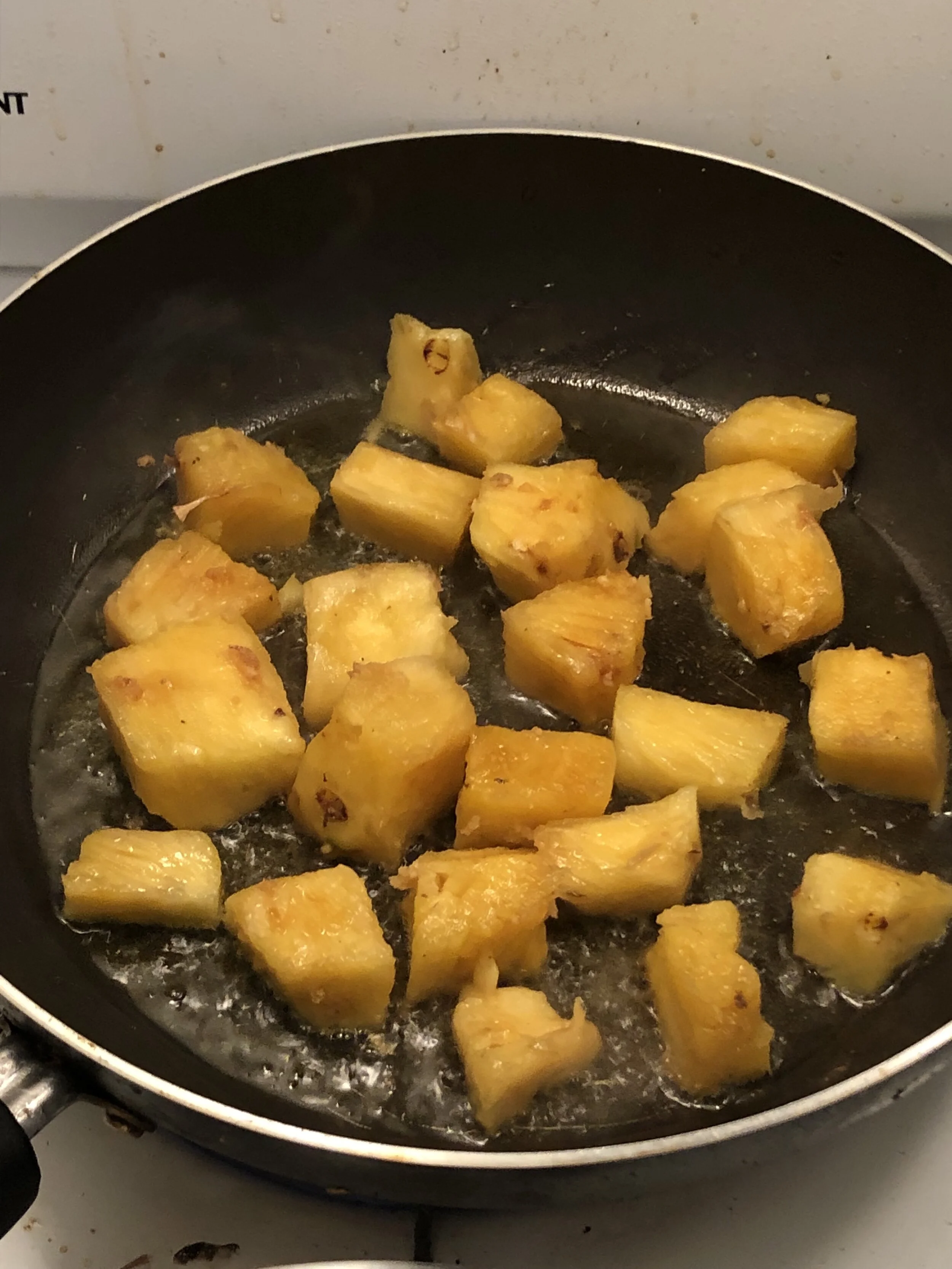 Cook on medium heat until browned on both sides. Remove the pineapple from the pan and set aside on a plate.
