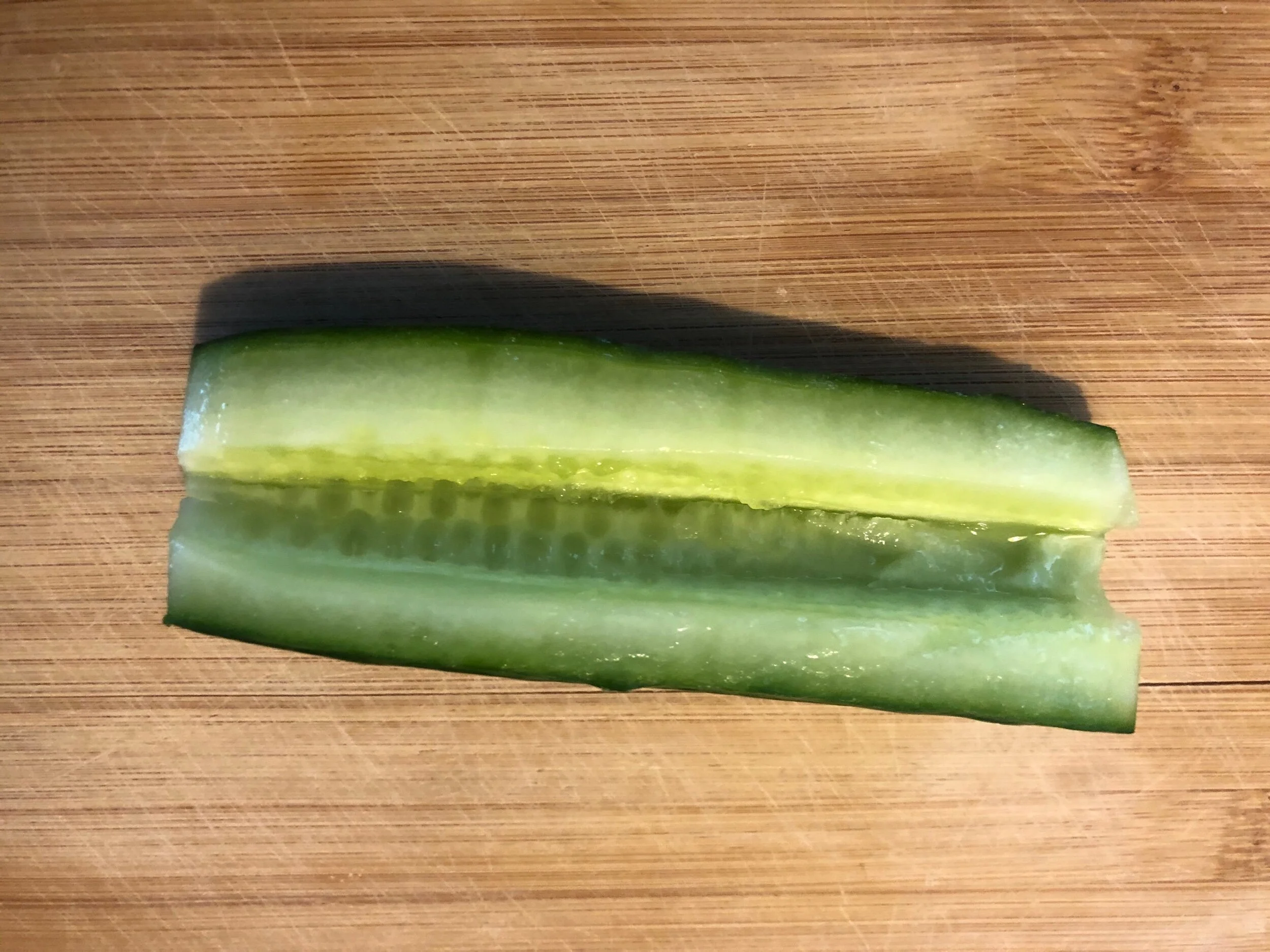 Cut your English cucumber into 2 pieces an during your paring knife, cut a triangular wedge shaped channel down the middle of your cucumber and discard the insides.