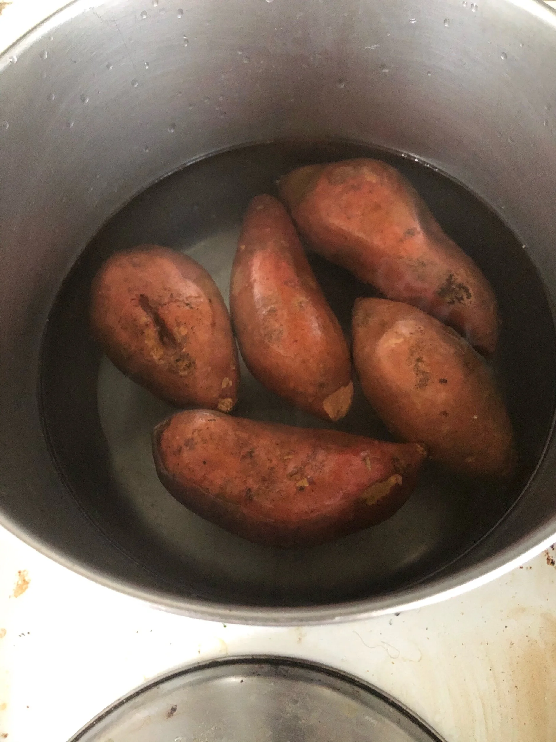 Bringing your stockpot to boil with salted water and after pricking your potatoes, place them in to cook.To expedite the cooking you can also cut them down the midline to make smaller pieces which will cook more quickly.