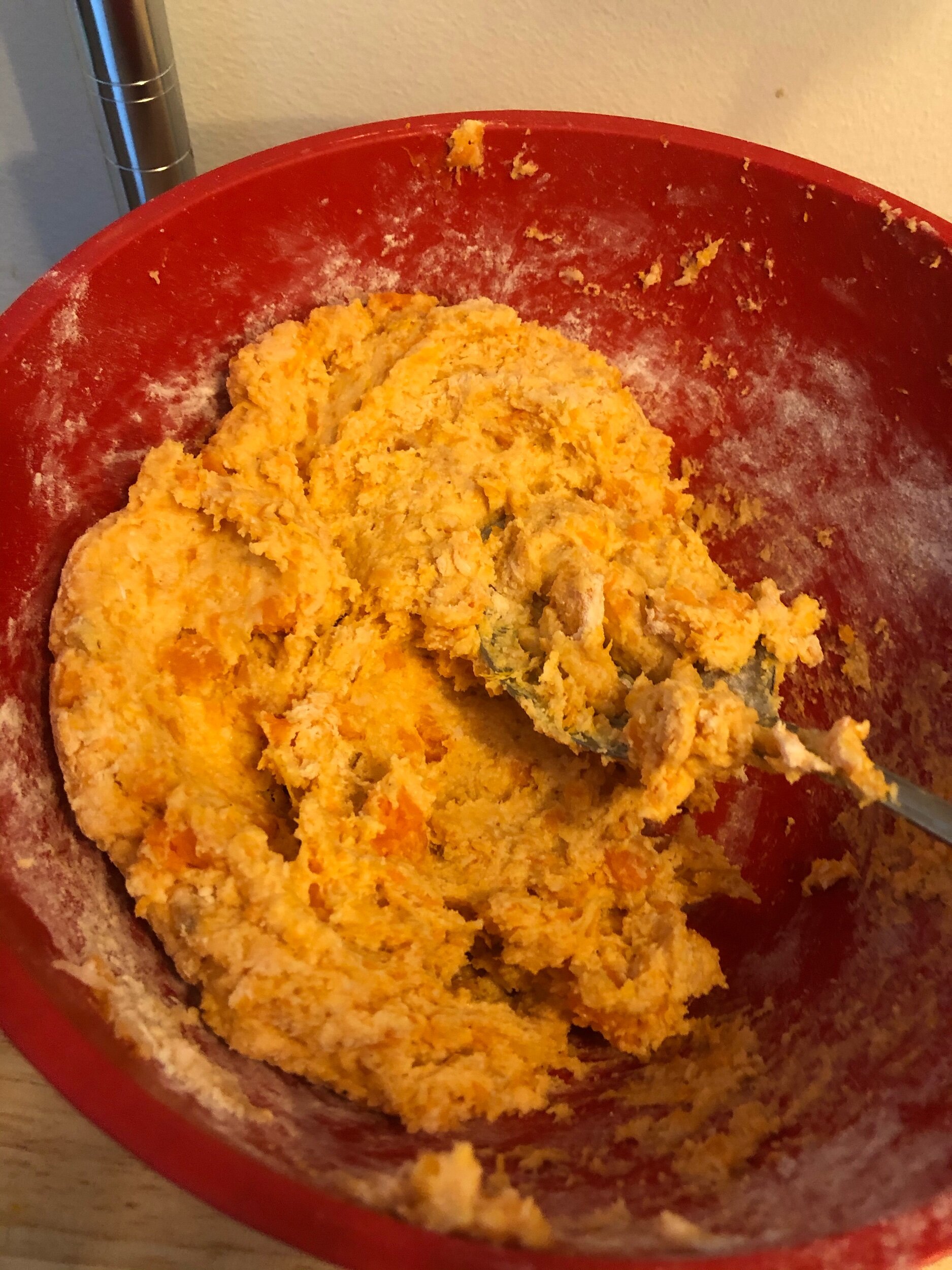 Mix the dough until it is the consistency of slightly sticky biscuit dough, being careful not to overwork it. Over working the tough makes tough gnocchi.