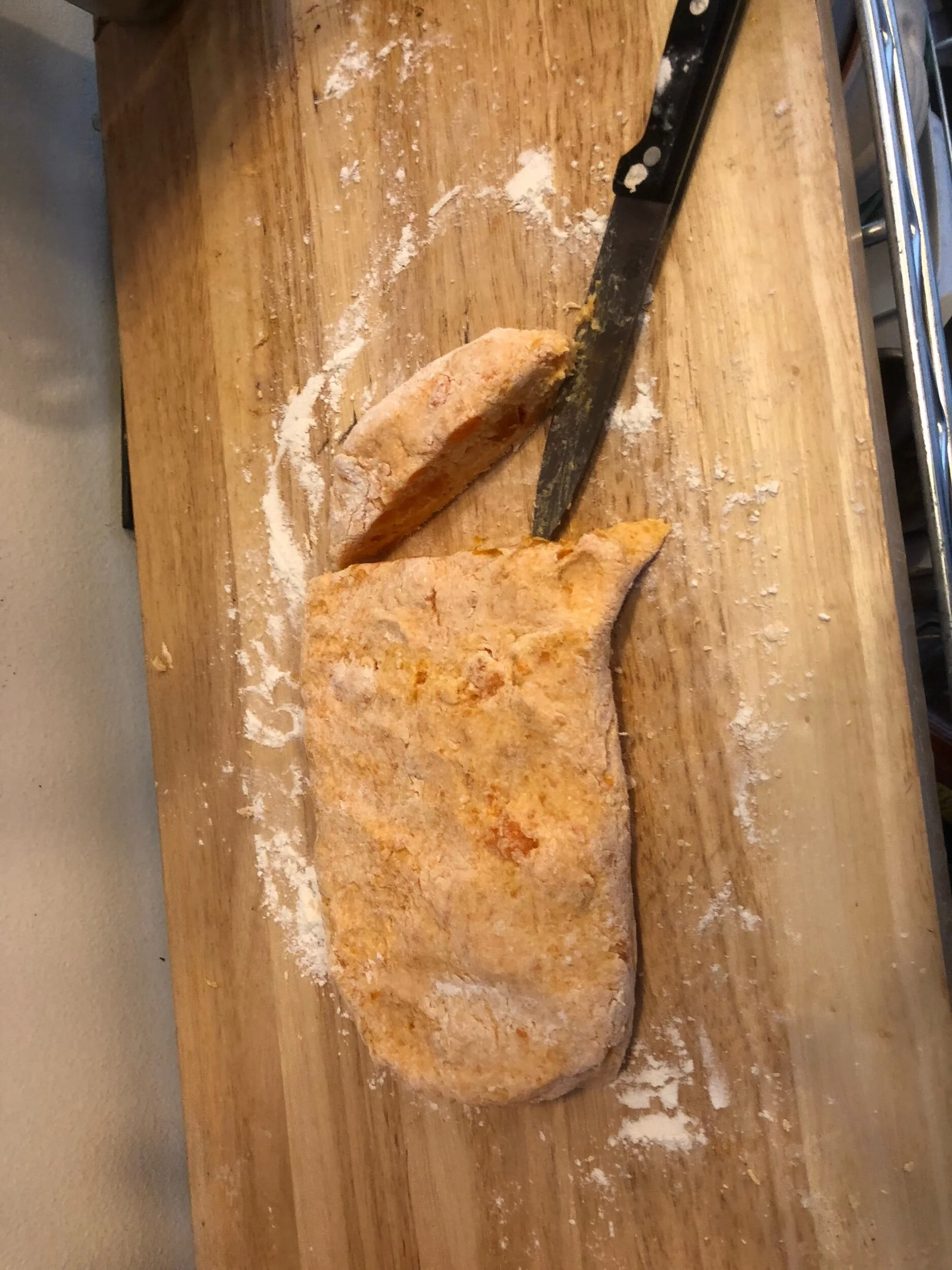 Taking a sharp paring knife, slice off the end (you will keep doing this and the next two steps until the loaf is sliced until individual gnocchis.