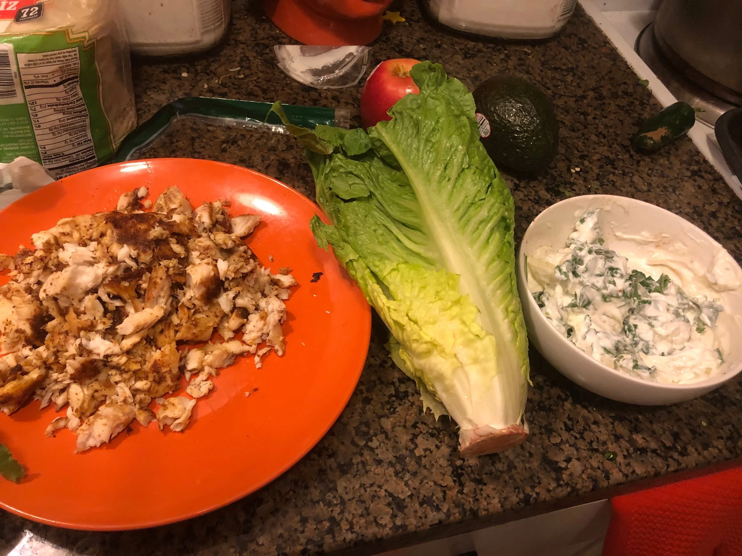 Remove the Romaine leaves, and clean them. Cradle two lettuce leaves together, place the fish in the spine of the leaf and dress with the crema.