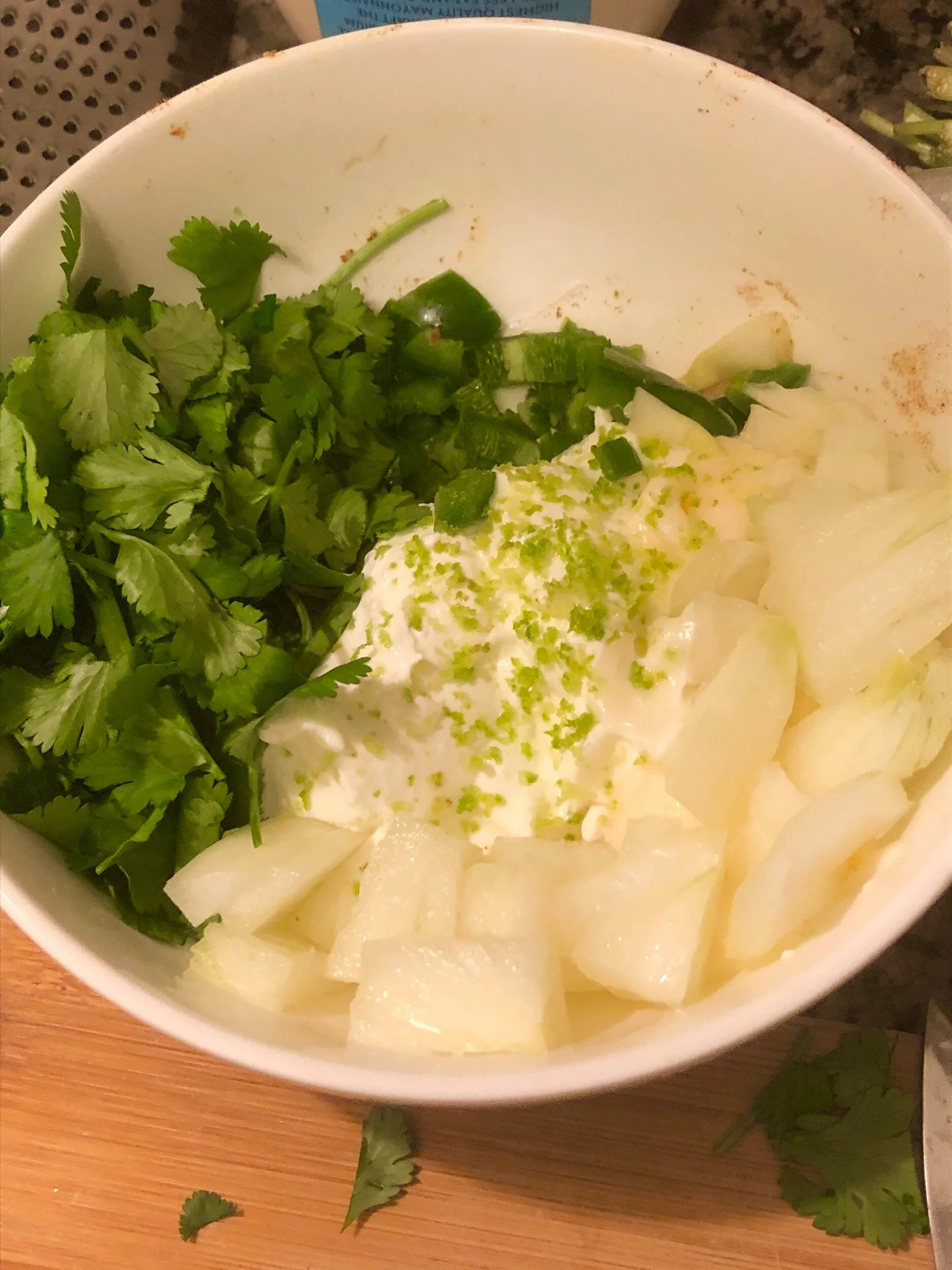 Add the cilantro and diced onion, and then add the diced jalapeño