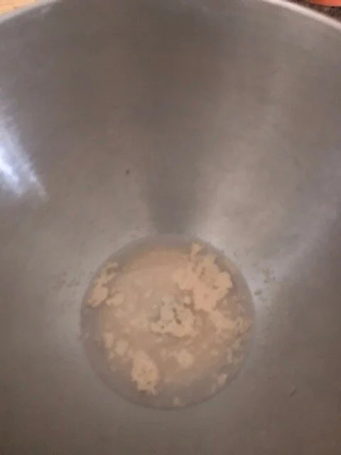 Dissolve the yeast int he warm water. Add the sugar, shortening, salt, egg, water and 2 cups of flour. Mix in your standup mixer (I was supposed to use another attachment to mix, but used the dough hook and it worked fine).