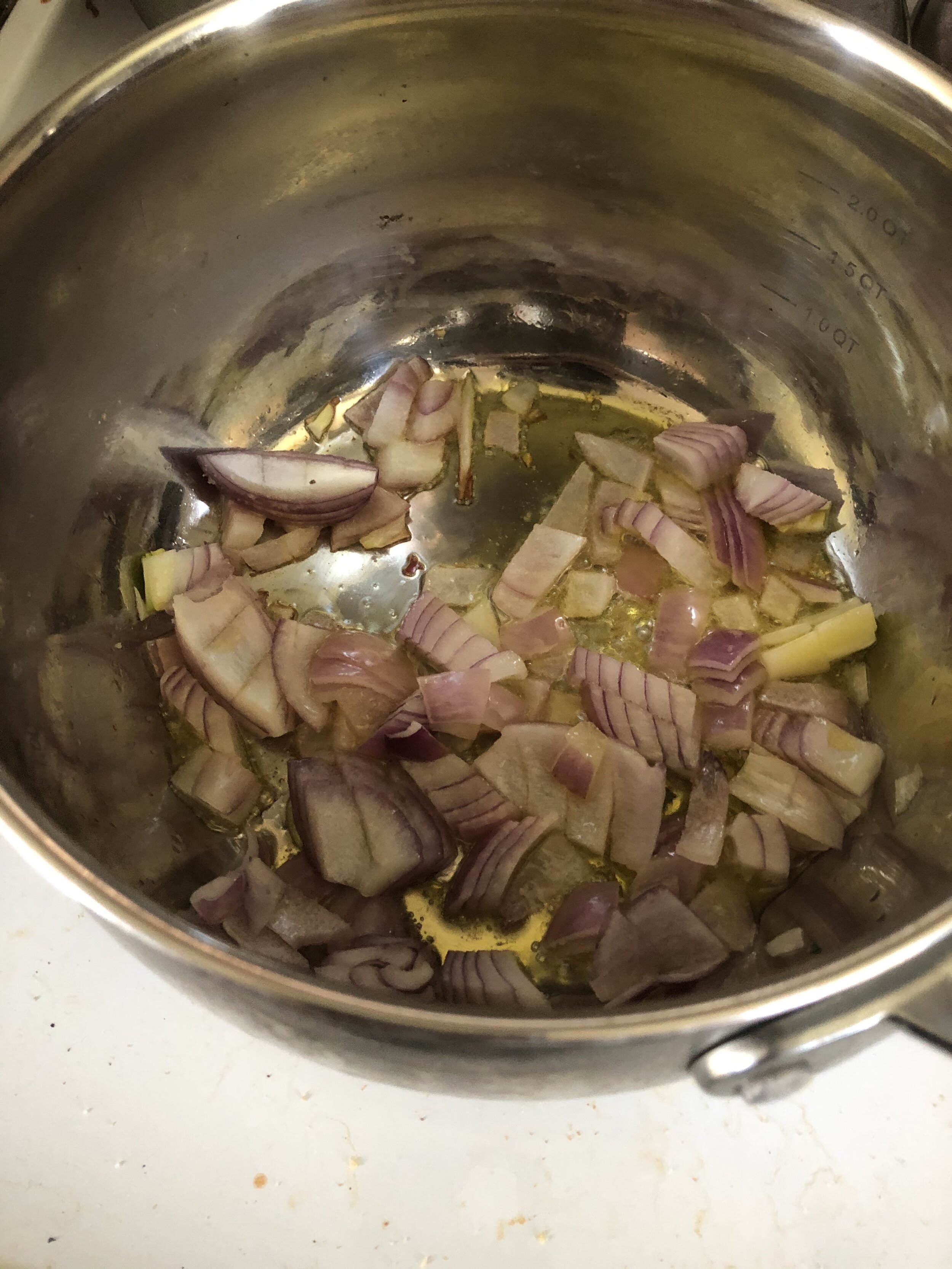 Add the olive oil to your medium saucepan and when hot add the onions, cook until aromatic. Turn the heat to medium low, and then add the garlic, also cooking until aromatic.