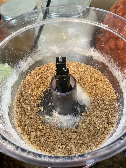 In a large bowl, sift together flour, baking powder and salt. Stir in coconut and pecans.