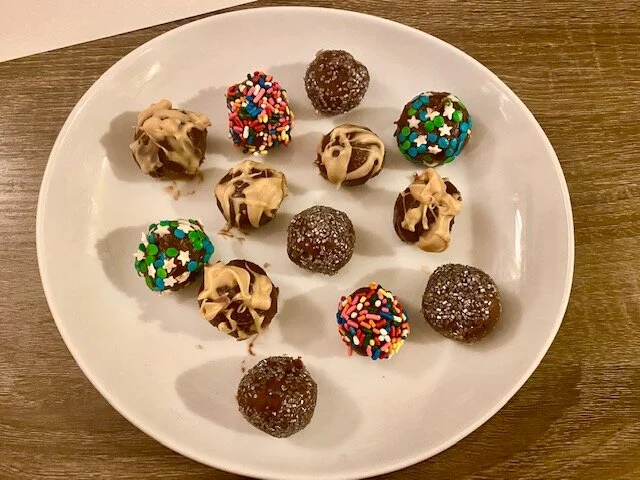 Decorate the truffles with decorative sugars, sprinkles and drizzle of a variety of mediums such as other types of chocolates or peanut butter.