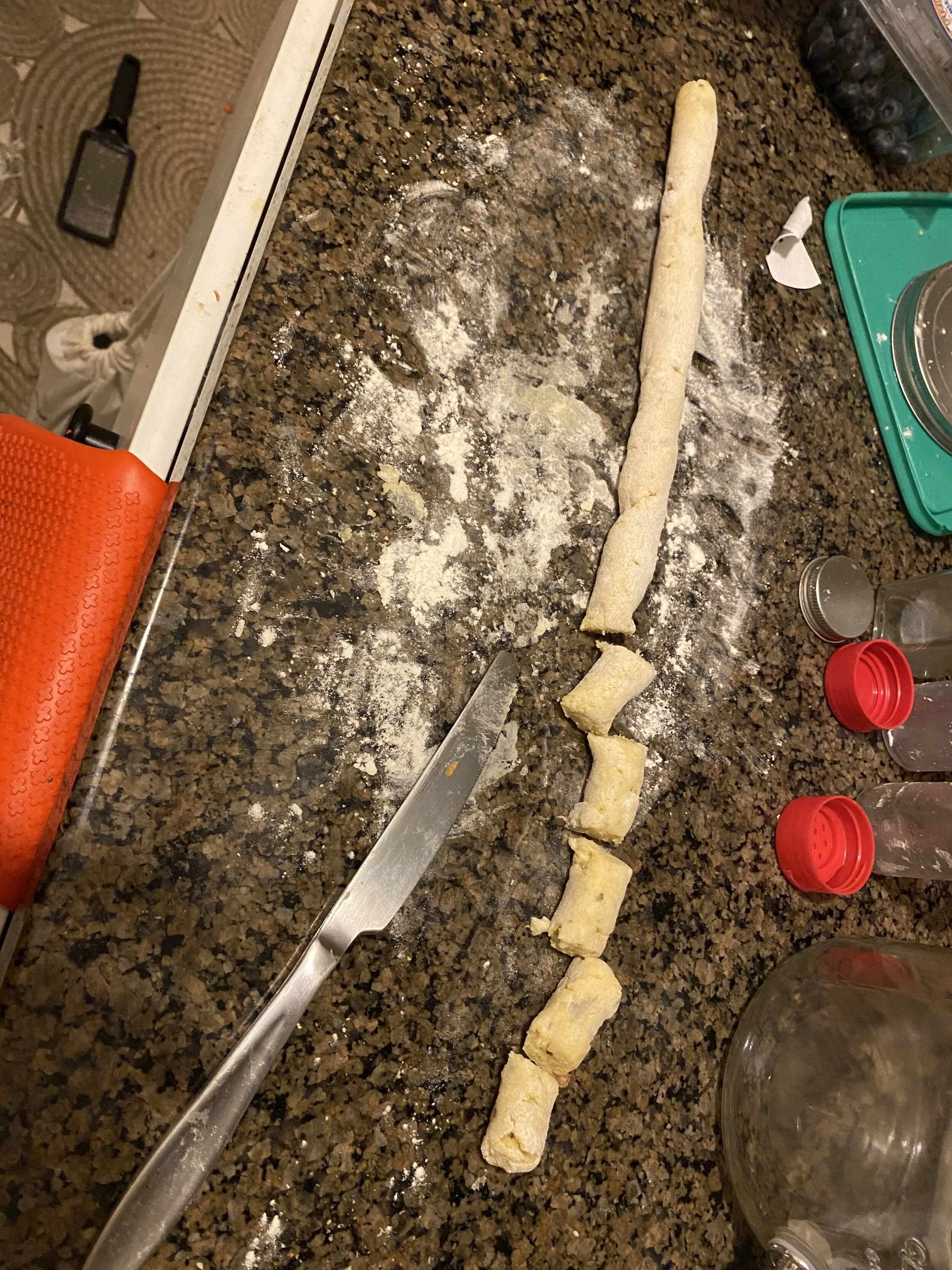 Put on a pot of heavily salted water at your highest setting. With heavily floured hands and a heavily floured surface, roll the gnocchi into logs (or as we in children’s craft speak say- medium logs)….Roll them until the logs are about 0.5 inch in …