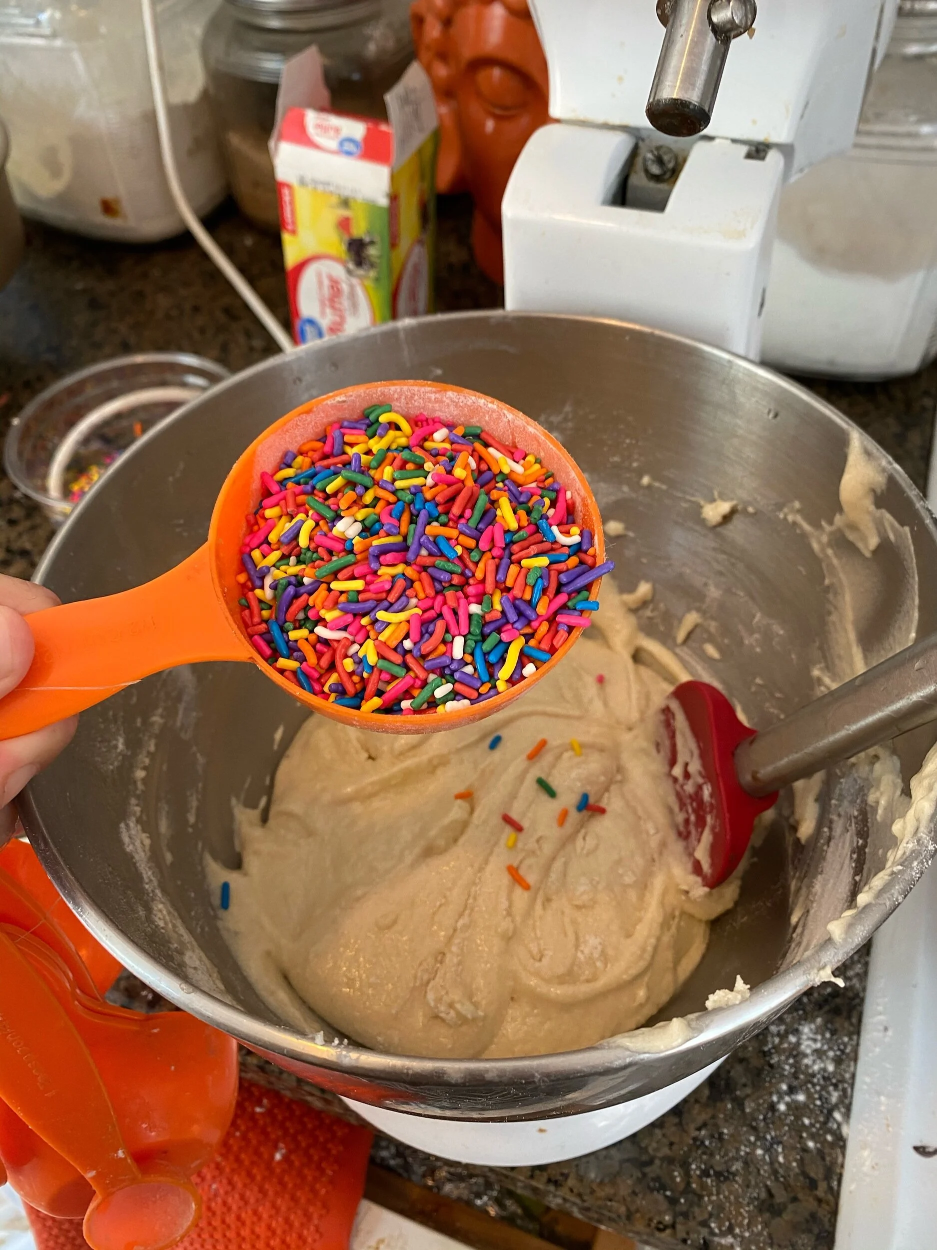 Remove bowl and use a spatula or spoon to mix in sprinkles by hand.
