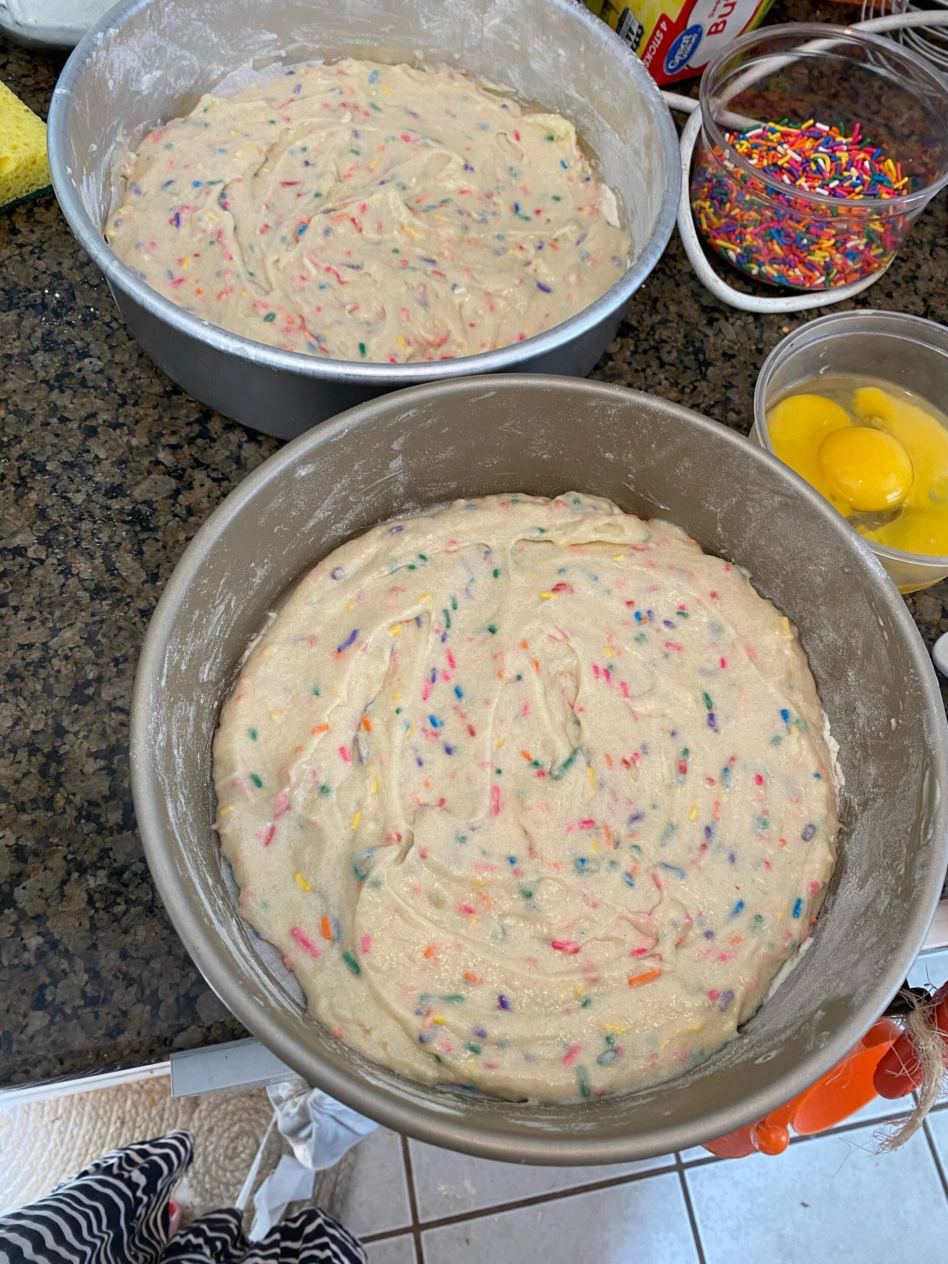 Pur even amounts in both pans. I had 9 inch, not 8 inch pans, so my cakes were thinner.