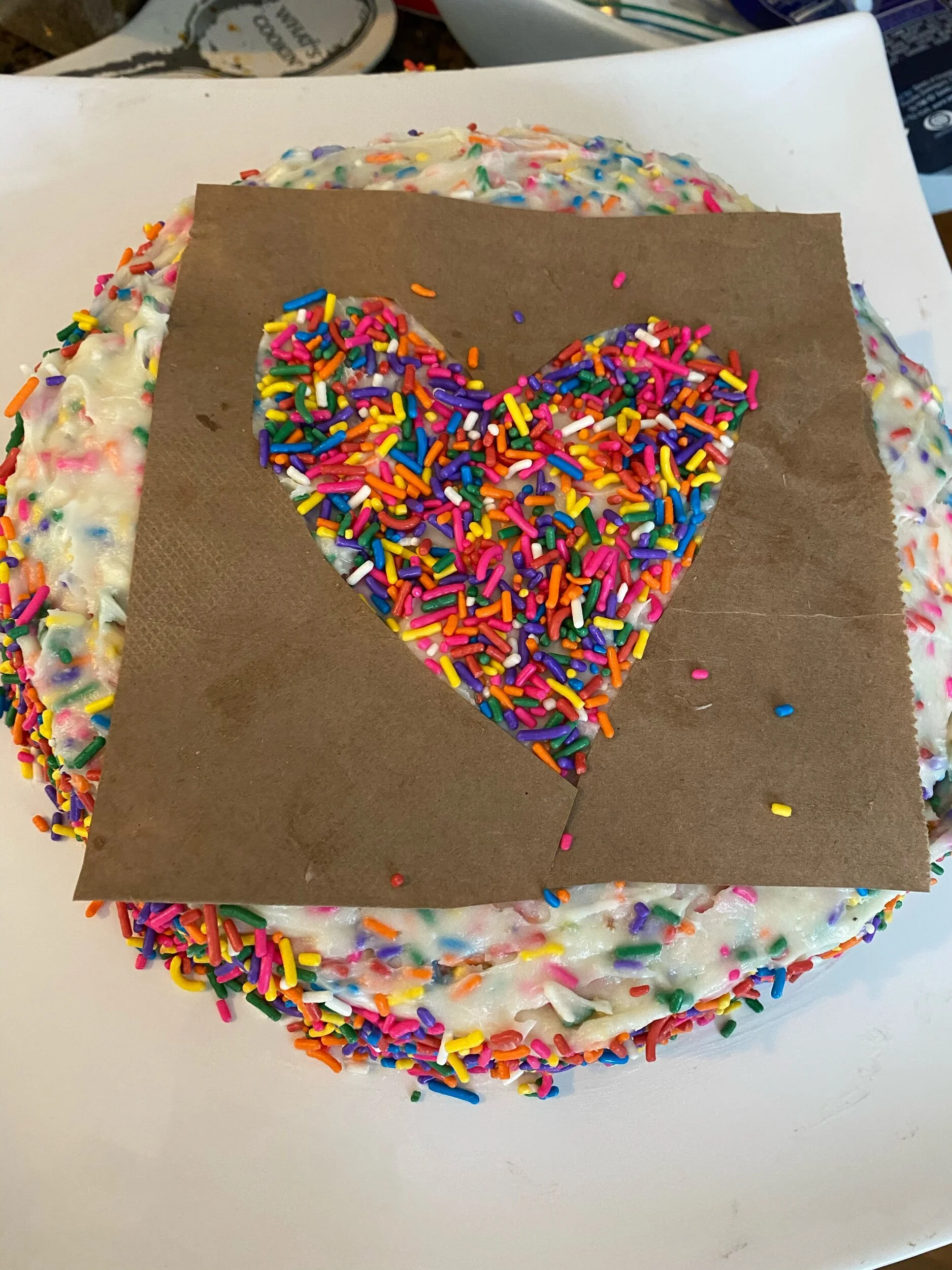 I made my own sprinkle stencil from a paper bag for some more sprinkle love! If making, if making on your own come upon a simple shape, cut out and place on top. You could tape the edge to avoid runaway sprinkles!