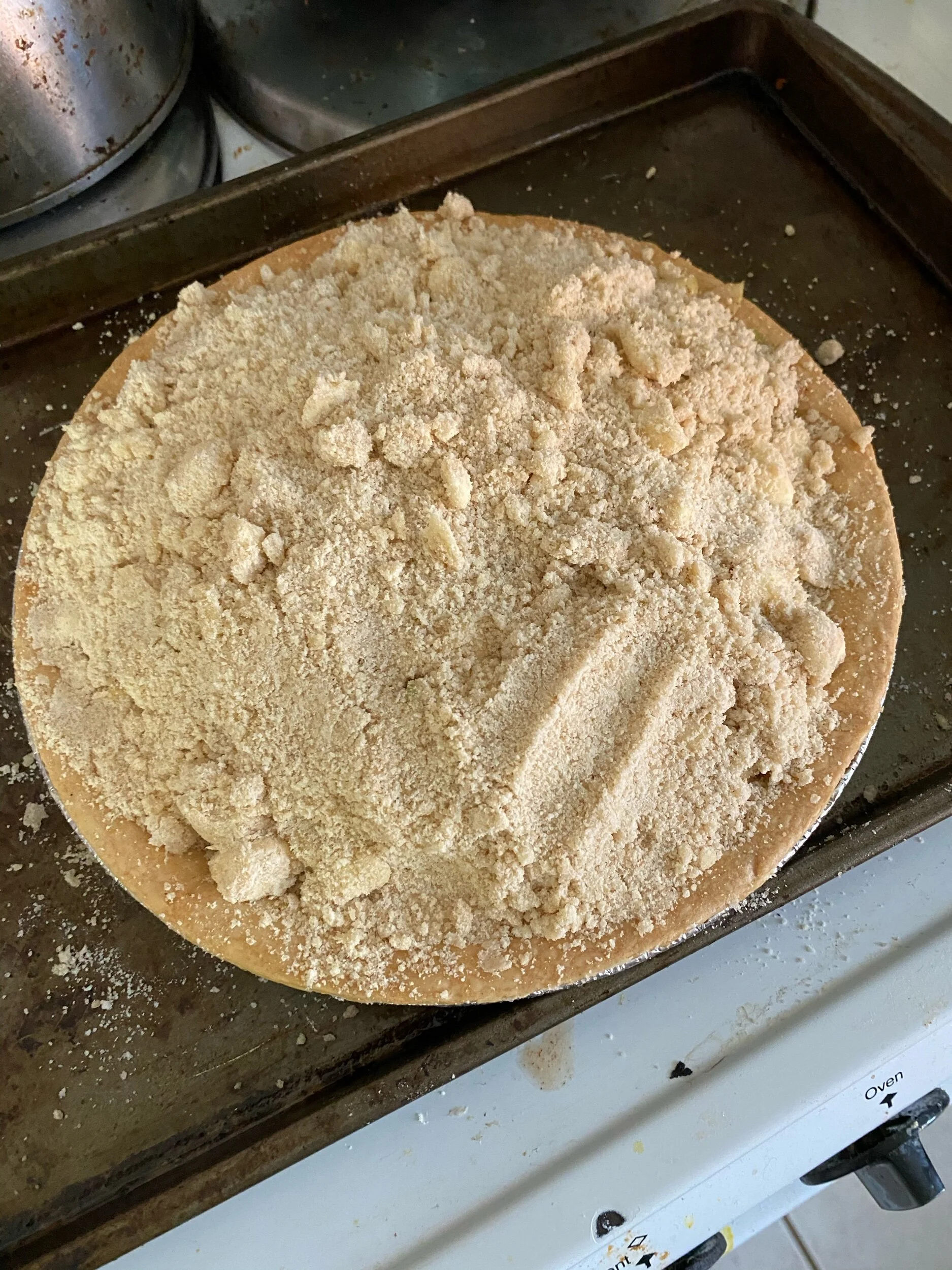 Mix the crumble topping. Pour your season apple slice filling into the pie shell and cover in the crumble topping.