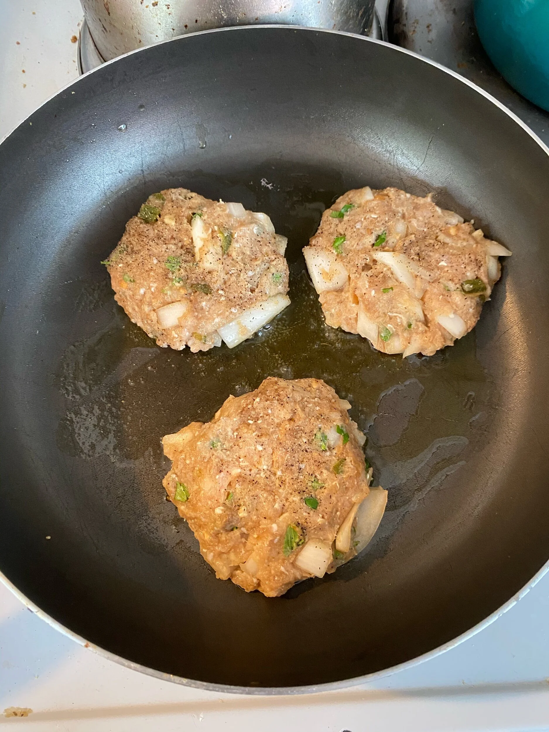 Keeping sure to ensure there is space in the pan, ad olive oil to your pan and cook the burgers over medium heat, covering if you desire to cook more quickly.