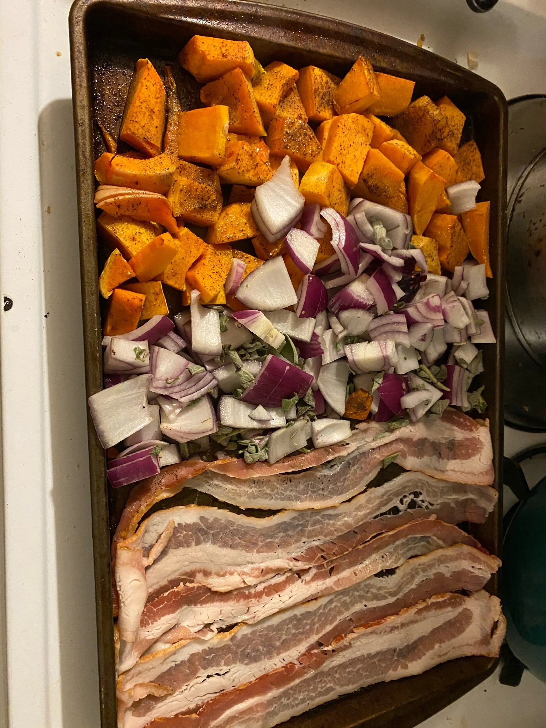 Toss onions in oliv eil , salt and pepper. Season with Rosemary and Sage. Lay the bacon strips to the far side of the pan.