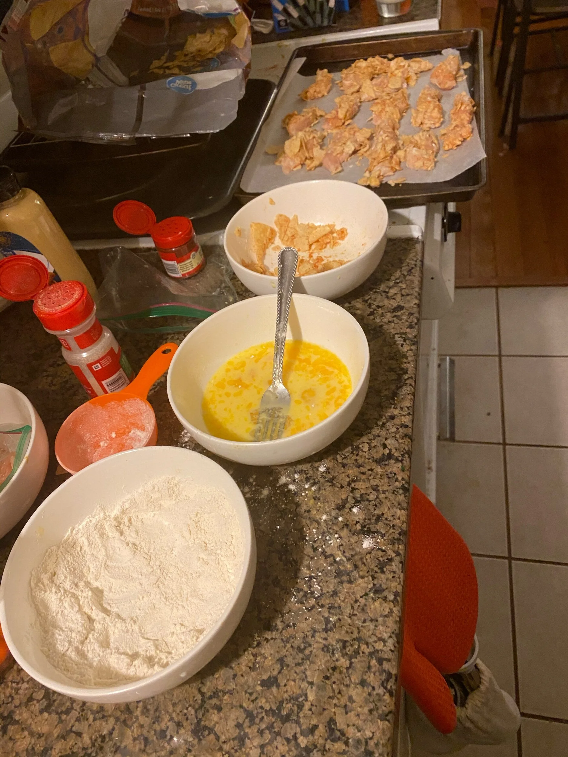 Clean the chicken of sinew and cut into sm strips…the tinier the piece, the quicker it will cook. Cut into very similar sizes though so they cook evenly. Whisk the eggs and add your milk to the egg mixture. Crush the “crunches” either using your han…