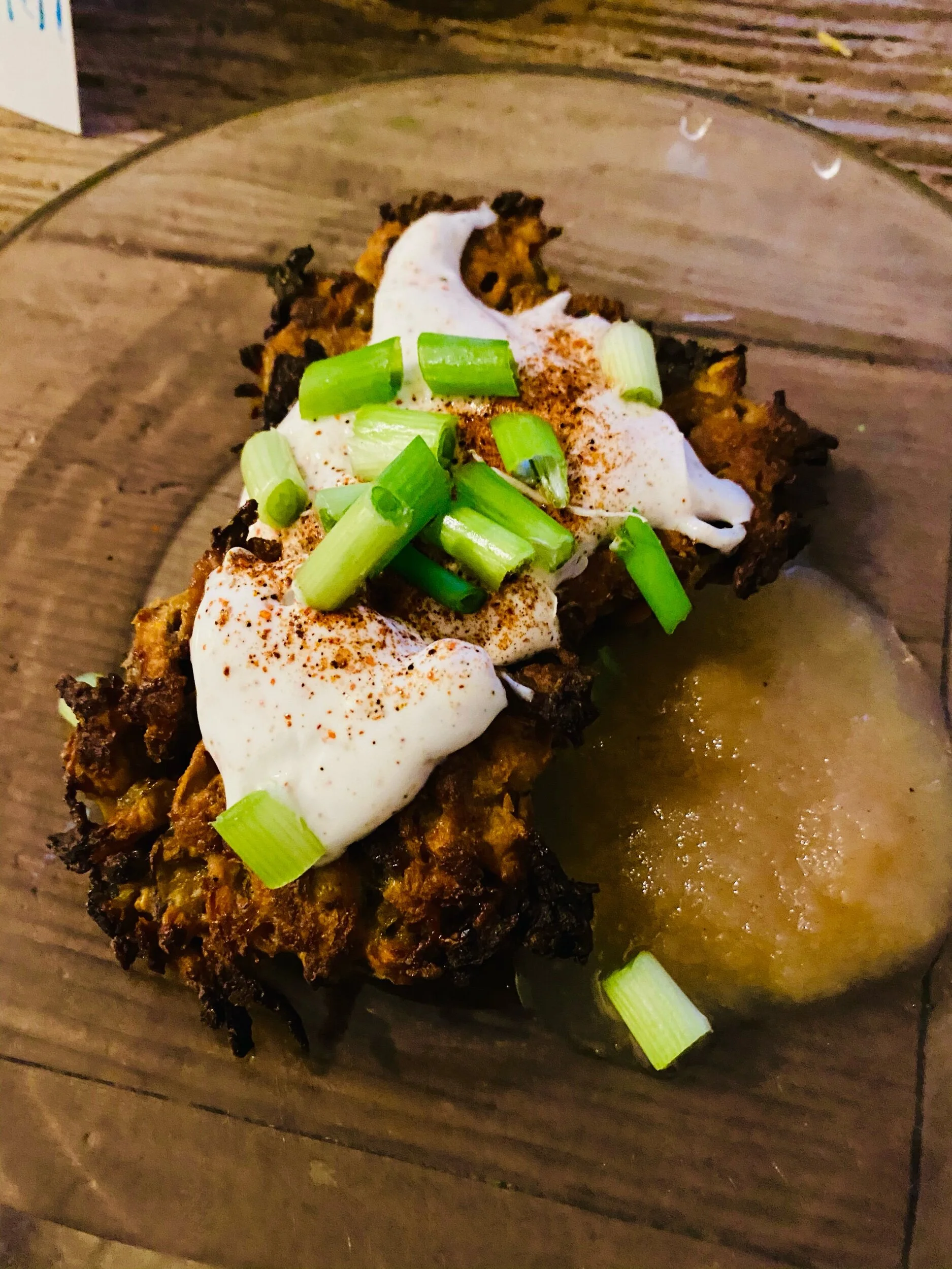 Mix the yogurt and cayenne pepper, pour generously over the hot latkes, drizzle with diced green onions (called scallions by you fancy folk) and our some applesauce on the side in something more generous than an actual smear….
