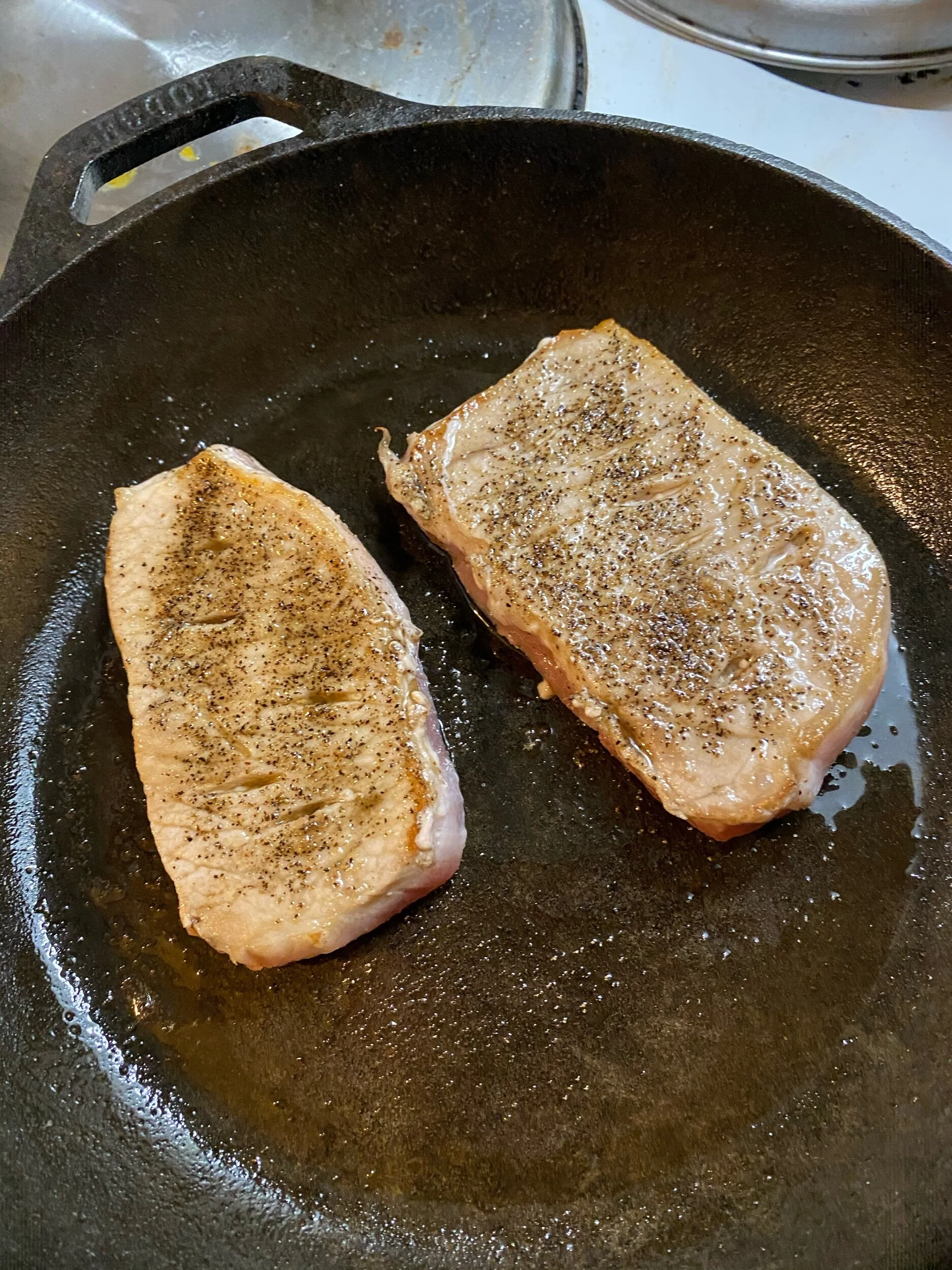 Sear both sides of the pork shop in the hot pan (2-3 minutes on each side).