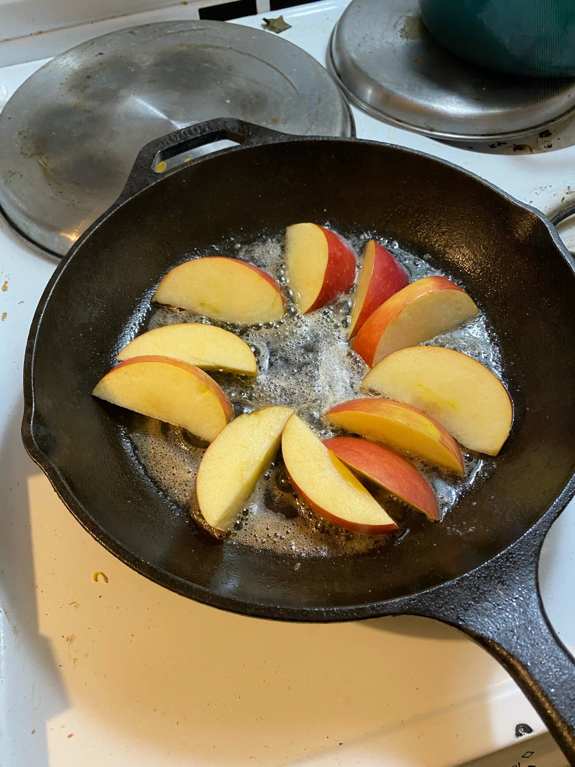 Remove the pork chops from the pan and set aside. Pout your pat of putter into the skillet and while it melts, cut the apple(s) into same size wedges. Place into the melted butter over medium heat.