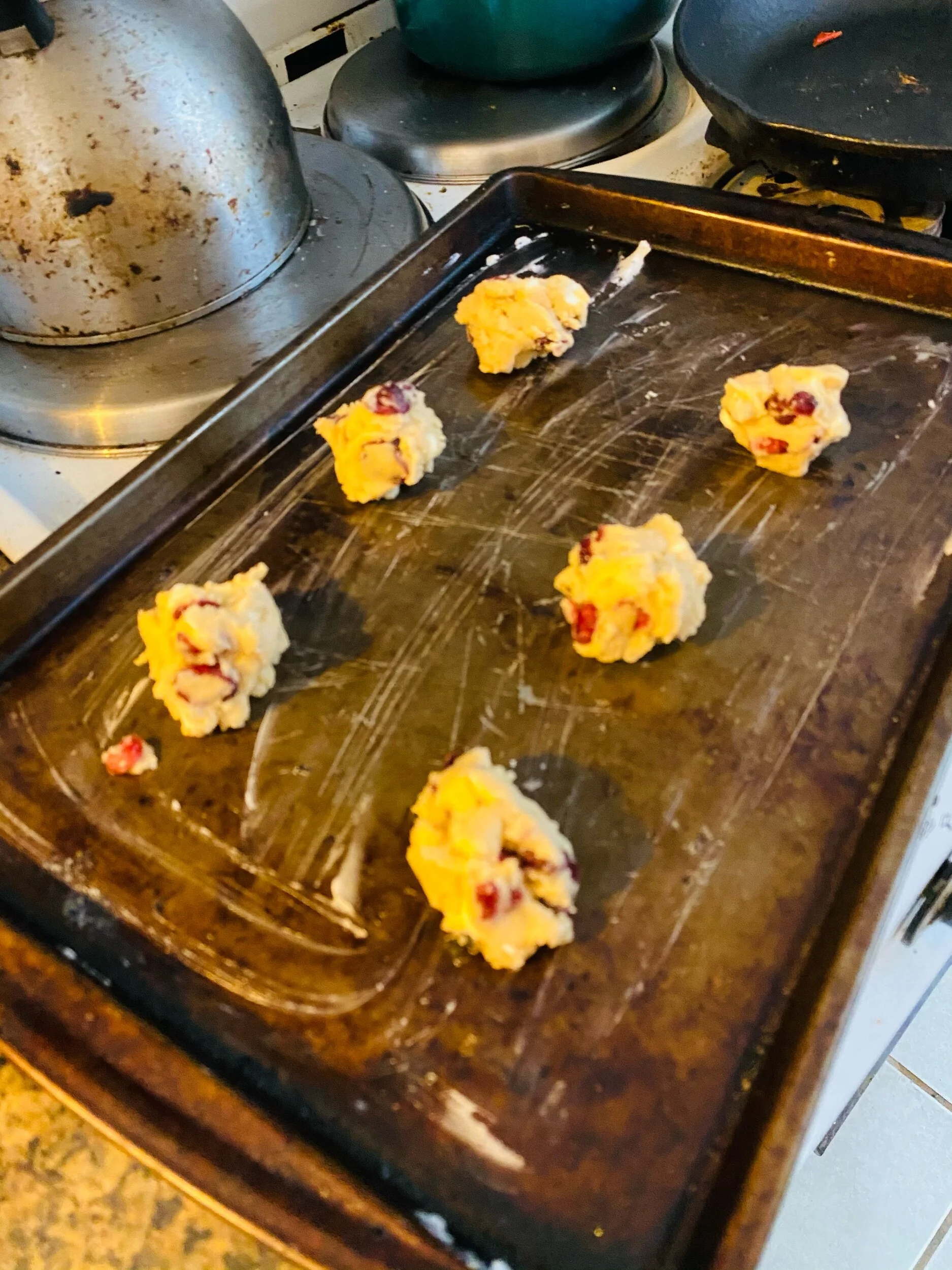 Grease Your cookie sheet (or use parchment paper) place 2 inch balls on the sheets spaced evenly. I happened to have crisco so used this but uou could also use butter, margarine or a nonreactive oil with a hugh smoking temperature.