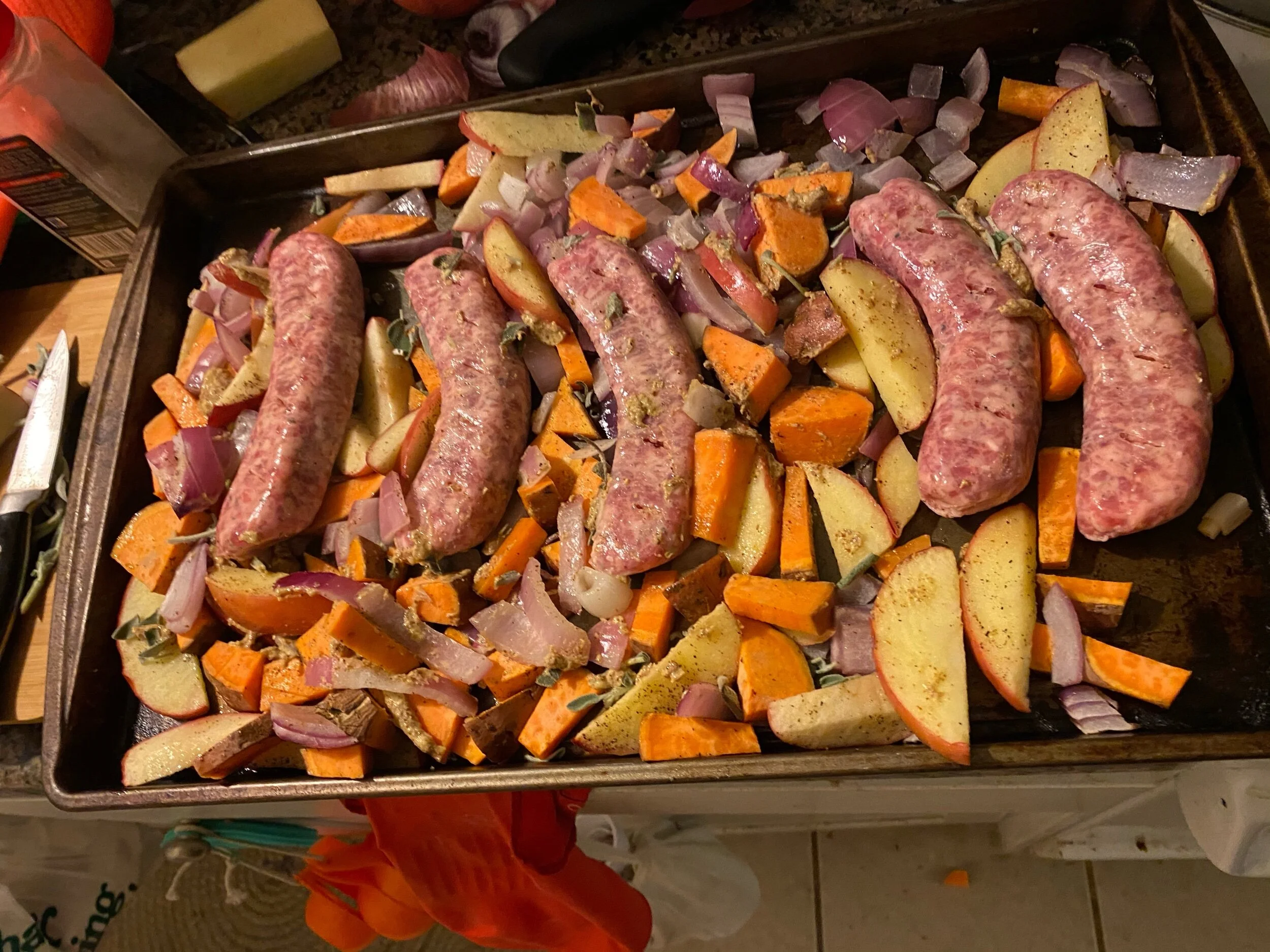 Put in the oven and toss with mustard and rosemary. Places the sausages, pricked with your fork, nestled in the pan.. Cook for 22-25 minutes.
