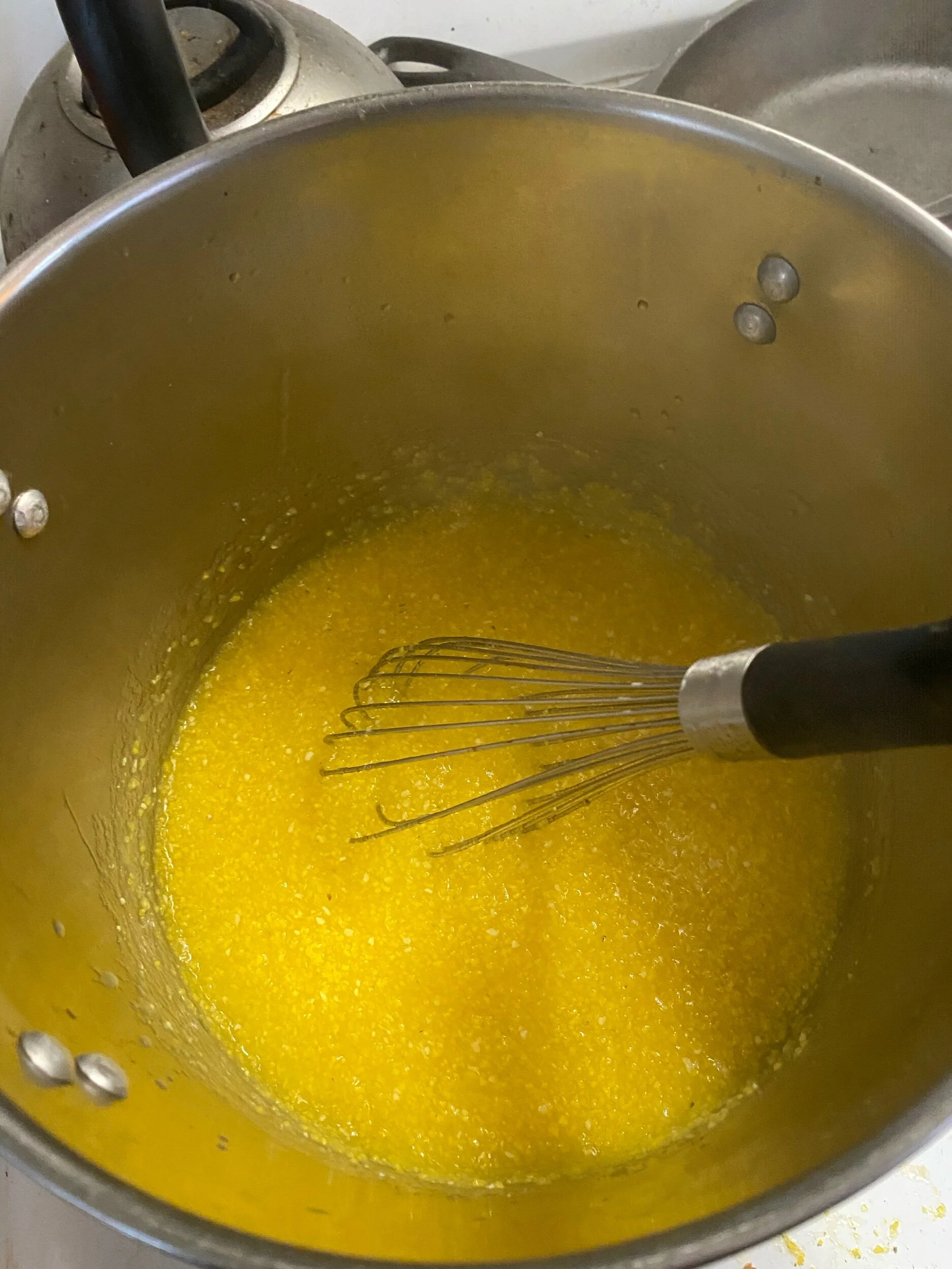 Prepare the polenta by adding cups of chicken stock over heat. Cook on medium and add the polenta bit by bit, whisking constantly. Keep whisking 8- 11 minutes and then whisk in butter. Remove the heat and mix in 1 cup of grated Parmesan.