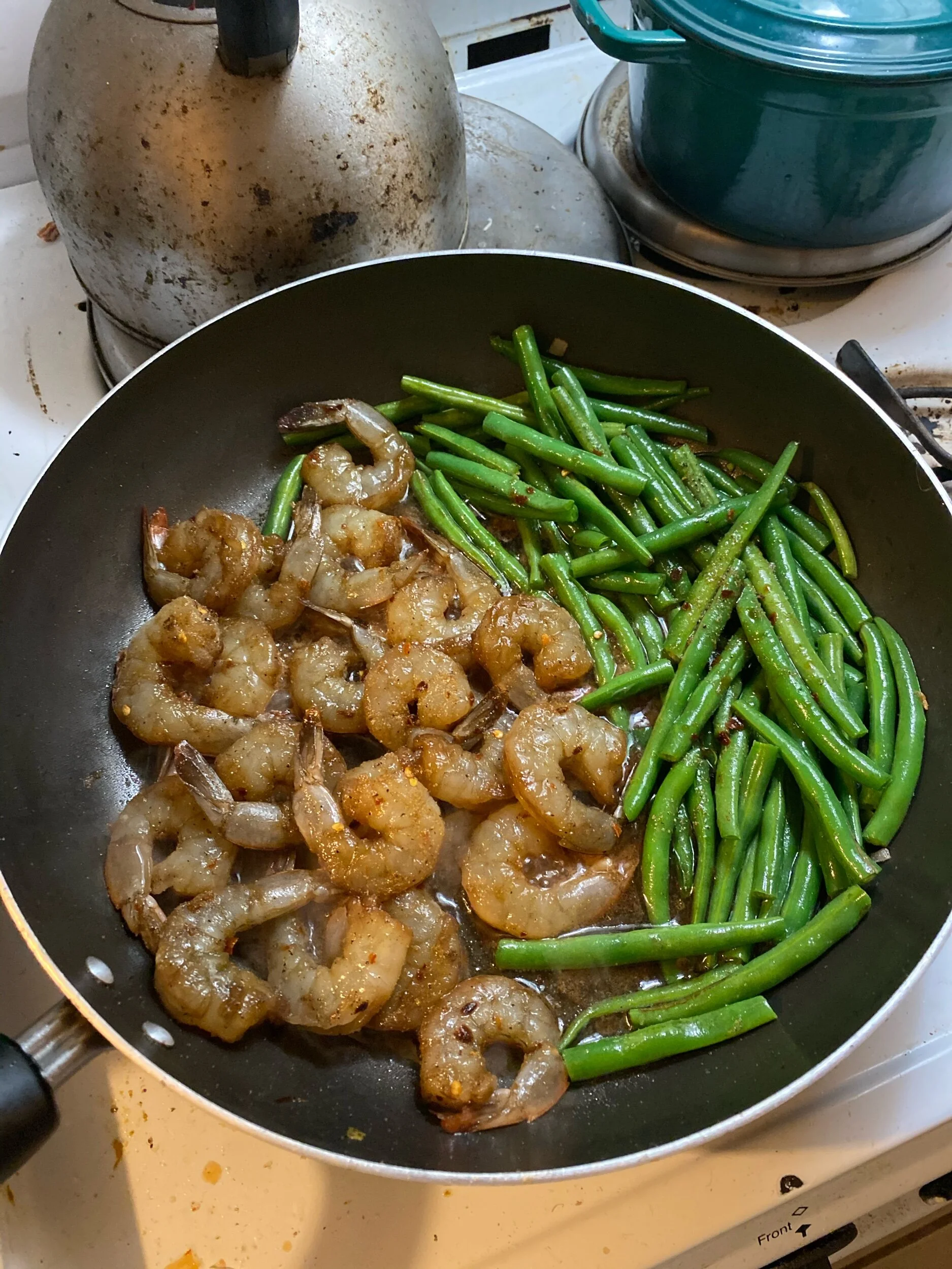 When the green beans have cooked, move them to the side of your pan and then add the shrimp to the space you just cleared along with the marinade. Cook the shrimp for 2-3 minutes on each side.