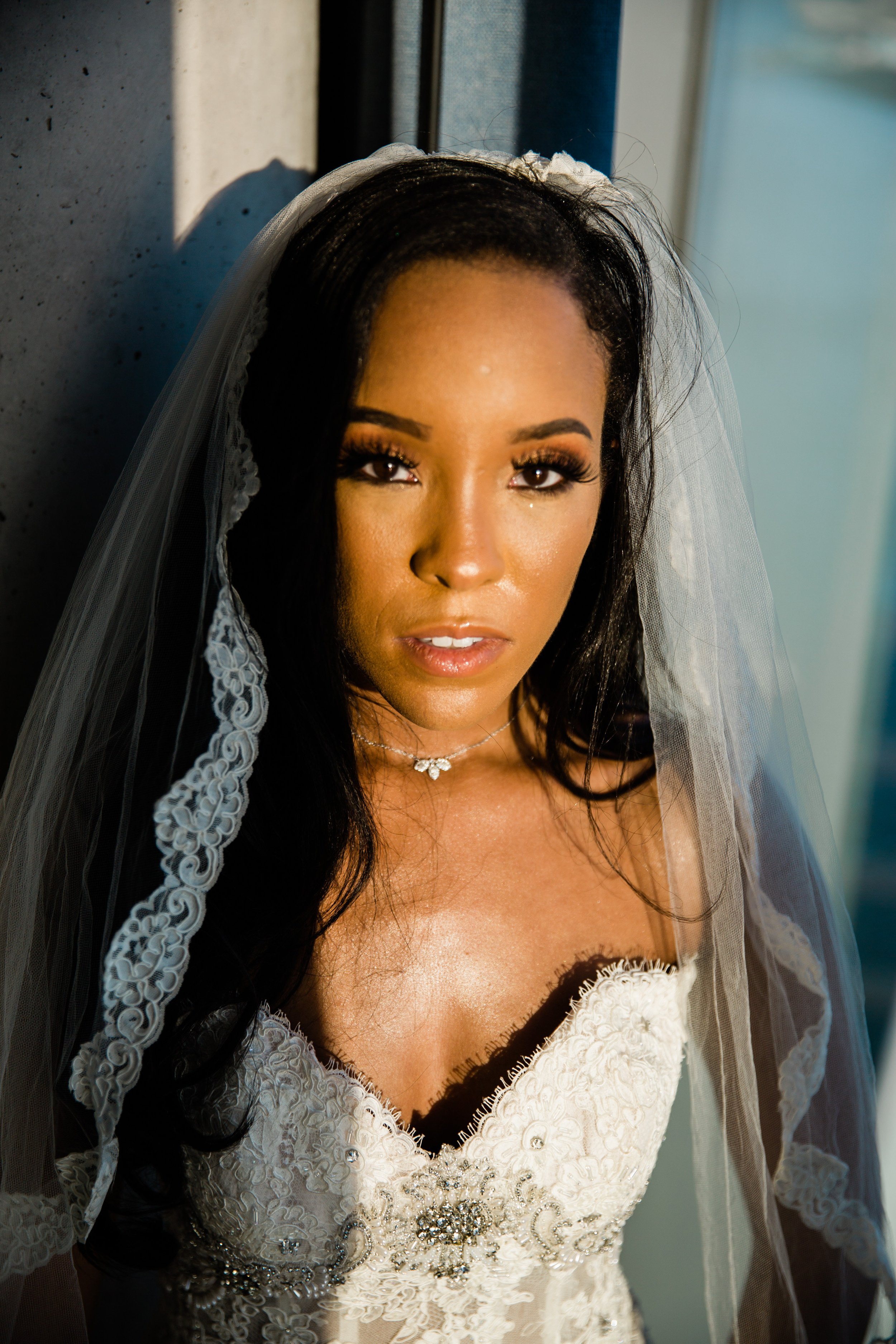 Black bride with lace trimmed veil staring