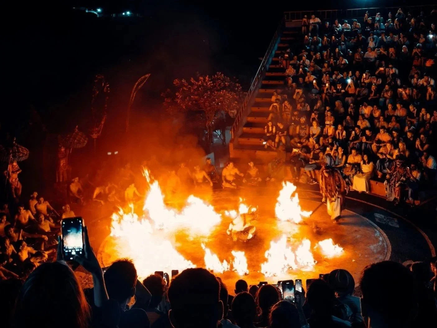 Kecak fire dance lighting up the Uluwatu Temple amphitheater at night, Bali