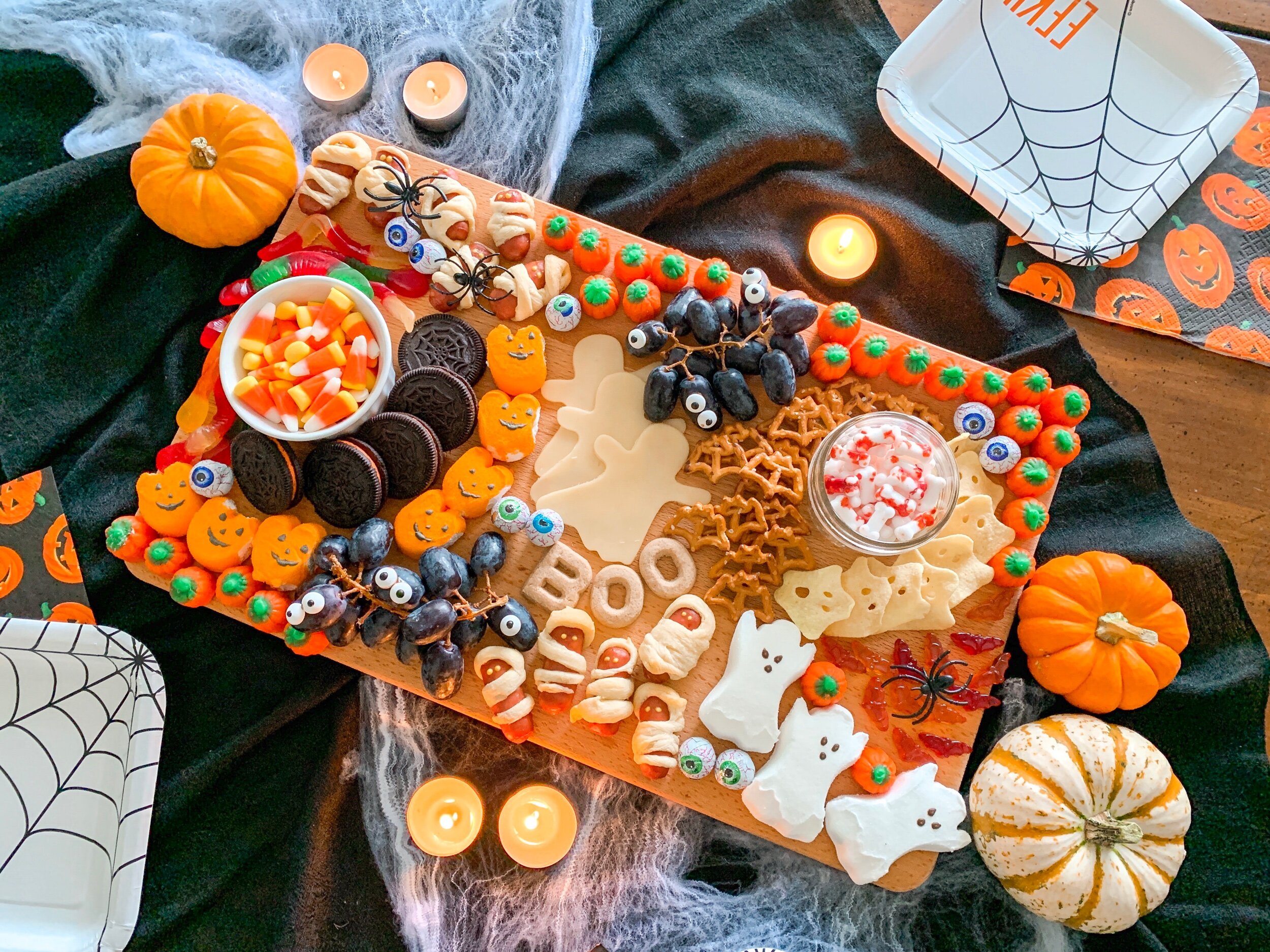 Mix candy, snacks and fruit for a fun and festive Halloween themed charcuterie board.