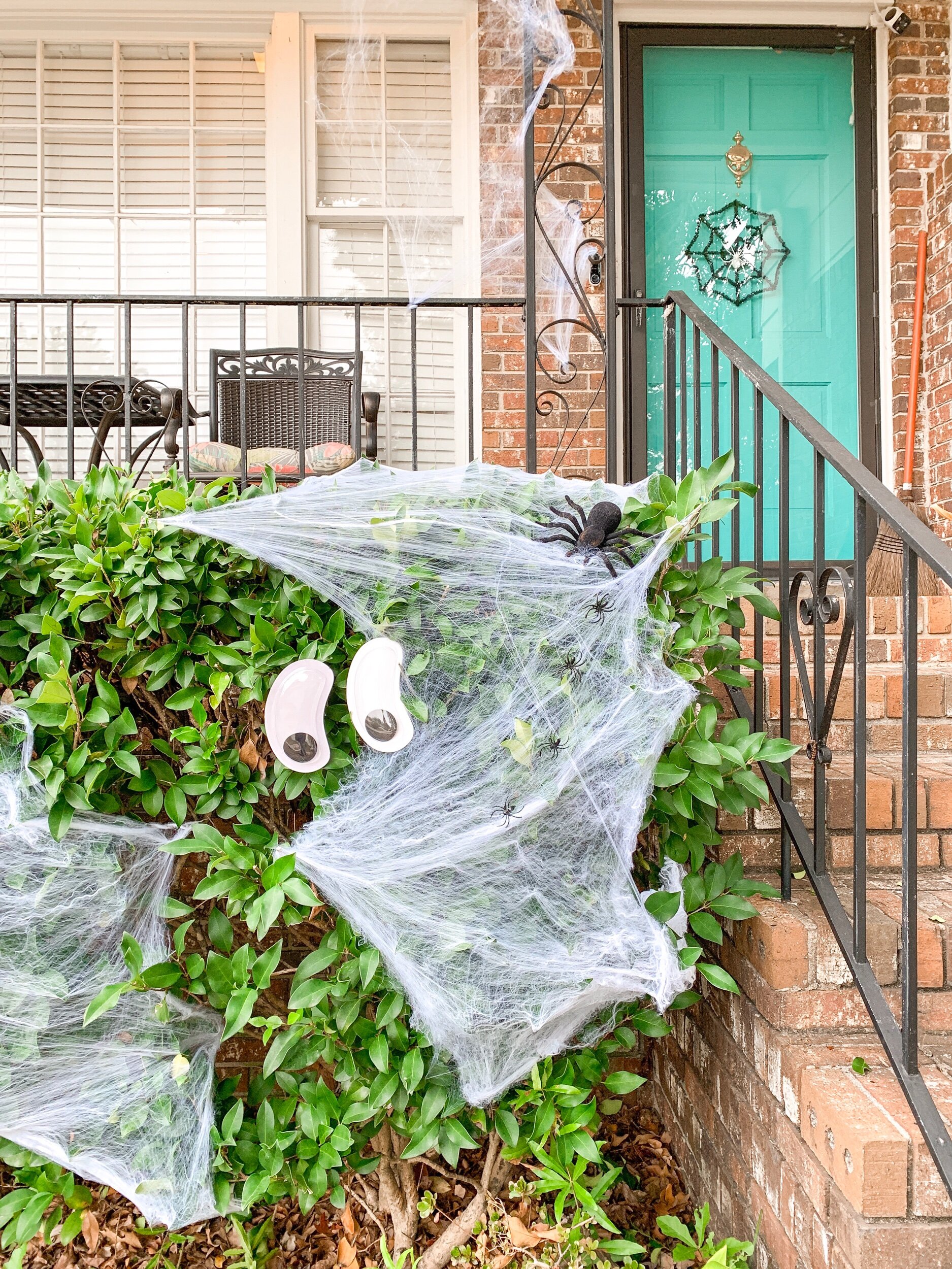 Glow in the dark googly eyes, spider webbing with little spiders, large fuzzy spider and spider door wreath are all affordable Halloween decorations from the Dollar Tree!!