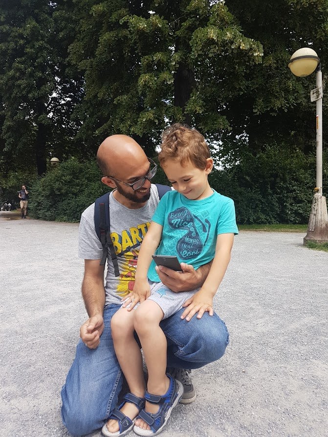 A proud father and his happy kid hunting Pokémon in Antwerp's Stadspark!