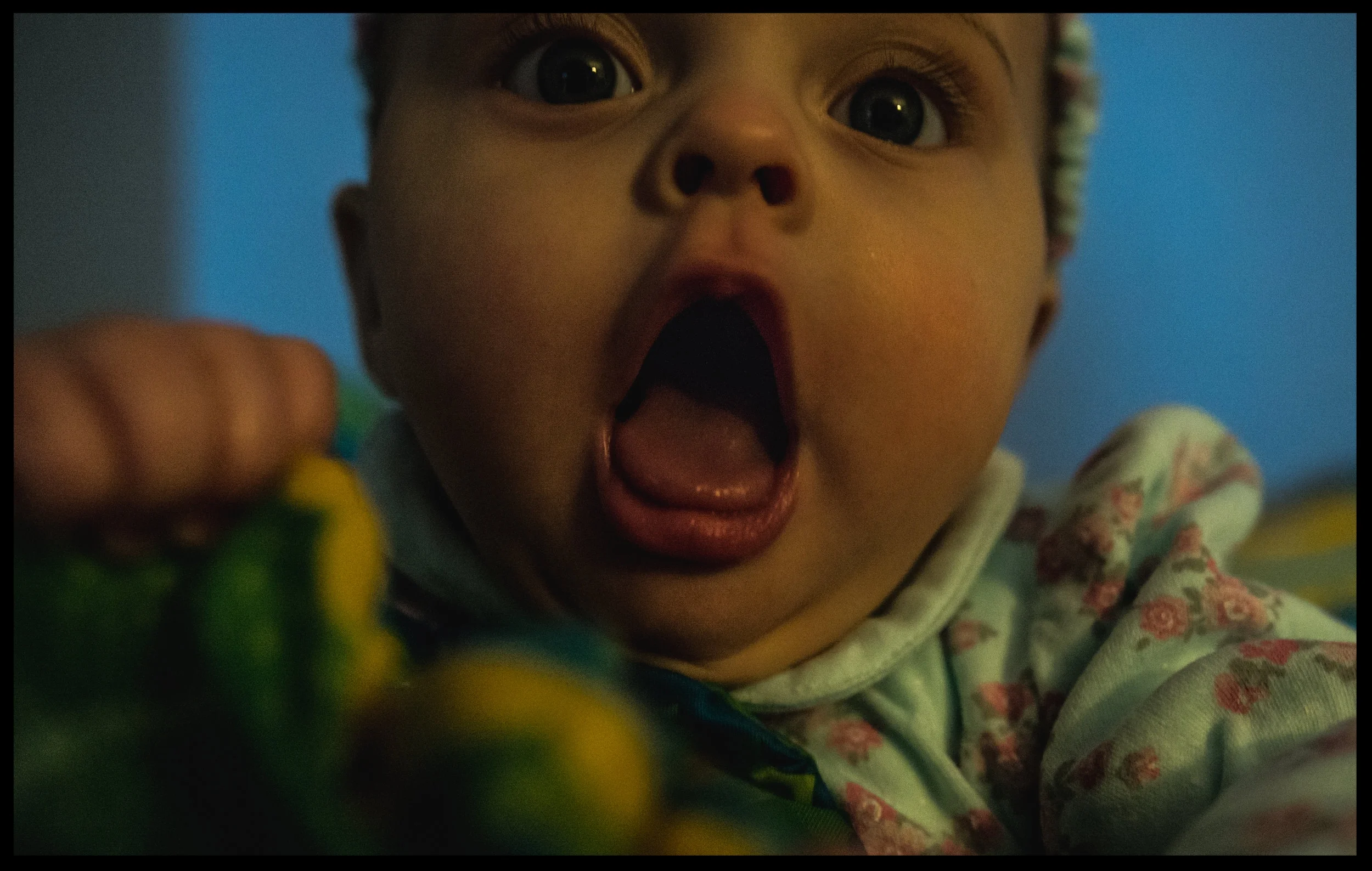 Baby girl with big bright eyes opens her mouth wide, color, Aurora, Colorado